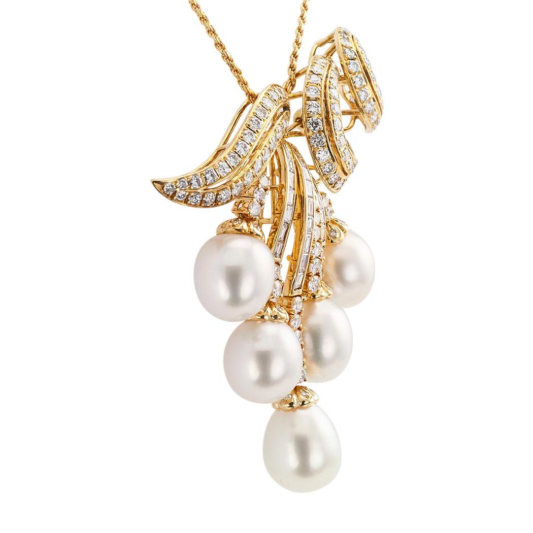 South Sea Pearls and diamond yellow gold brooch pendant circa 1980.

DETAILS:
PEARLS:  five South Sea pearls measuring on average 11.3 X 13 mm – 11.7 X 13.5 mm.
DIAMONDS:  one hundred forty-four baguette and round brilliant-cut diamonds totaling