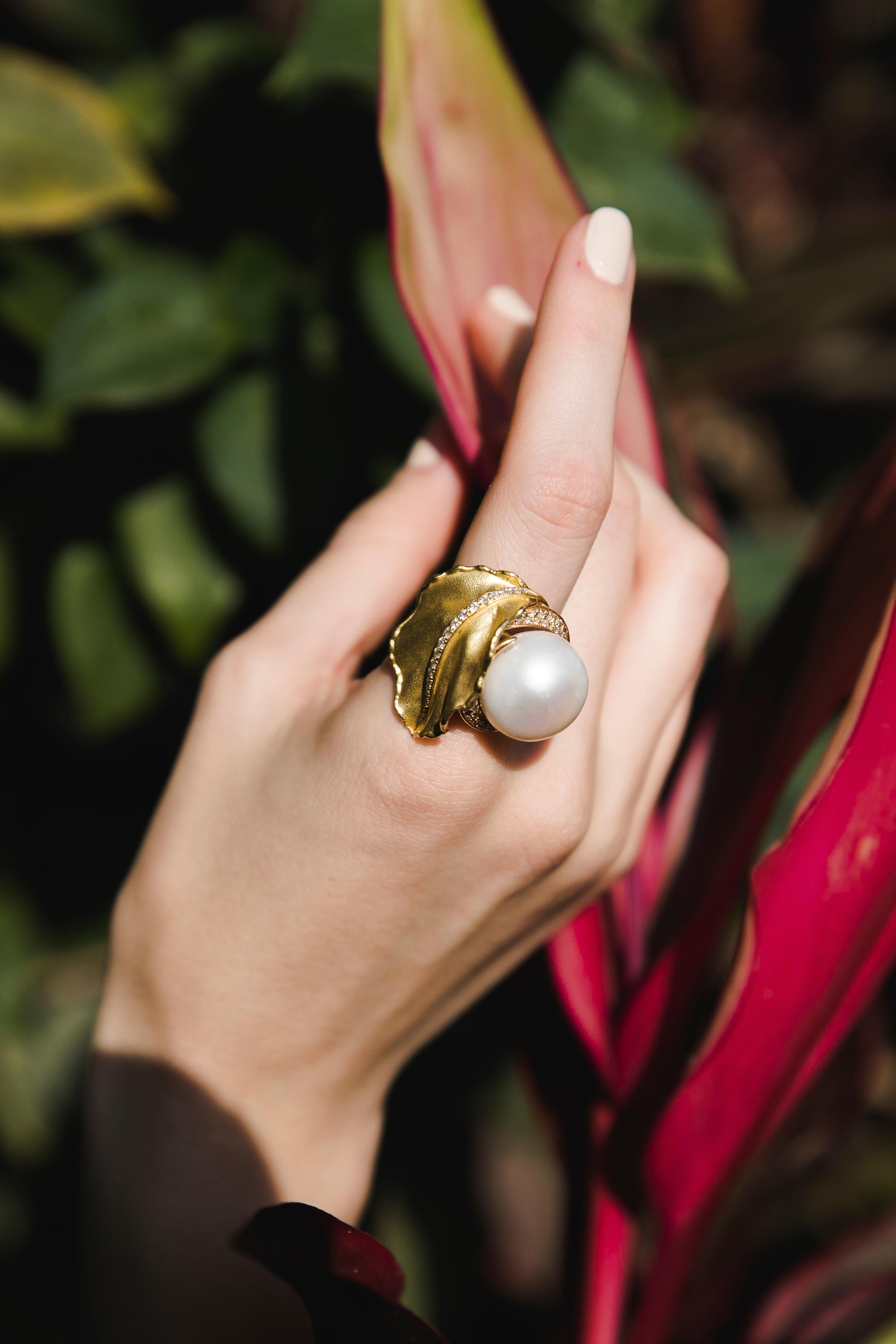 South Sea Pearl Diamonds 18 Karat Yellow Gold Floral Ring, 1970
Massive 17.5 mm South Sea Pearl masterfully rolled into a Yellow Gold leaf with a line of round-cut Diamonds.  1970es - an epitome of the Gold-rush era. Bold design lets you wear the