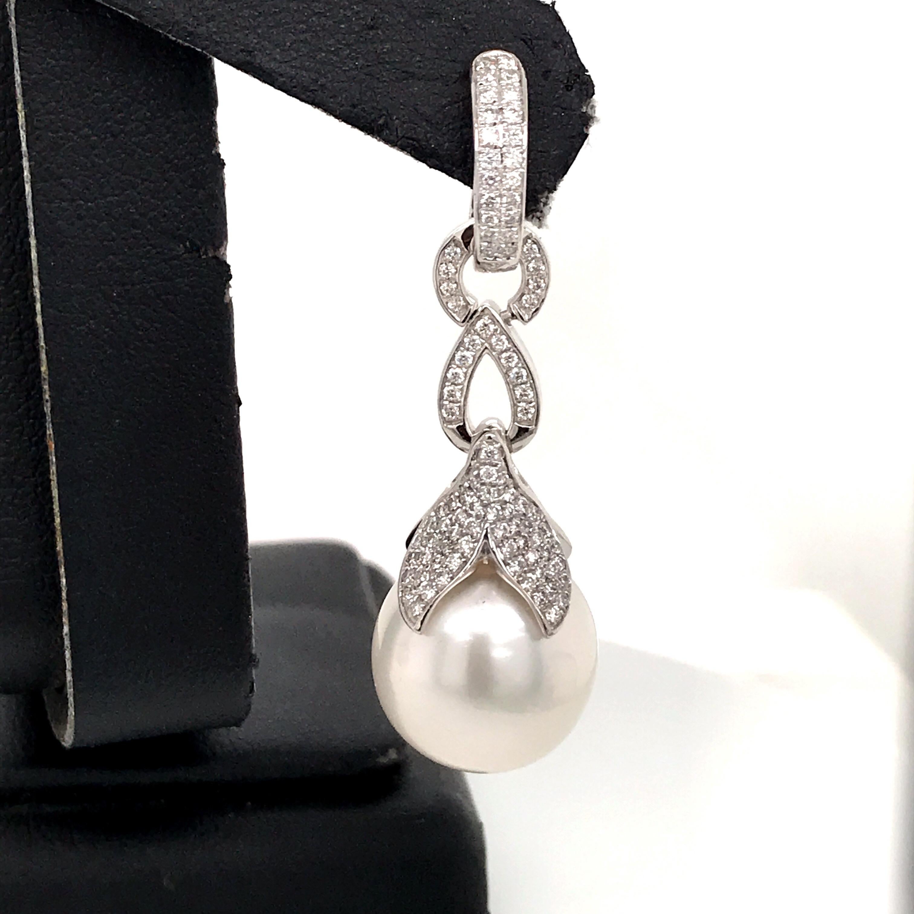 18K White gold drop earrings featuring two South Sea Pearls 13-14 MM WITH 188 round brilliants 0.77 carats. 
Color G-H
Clarity SI