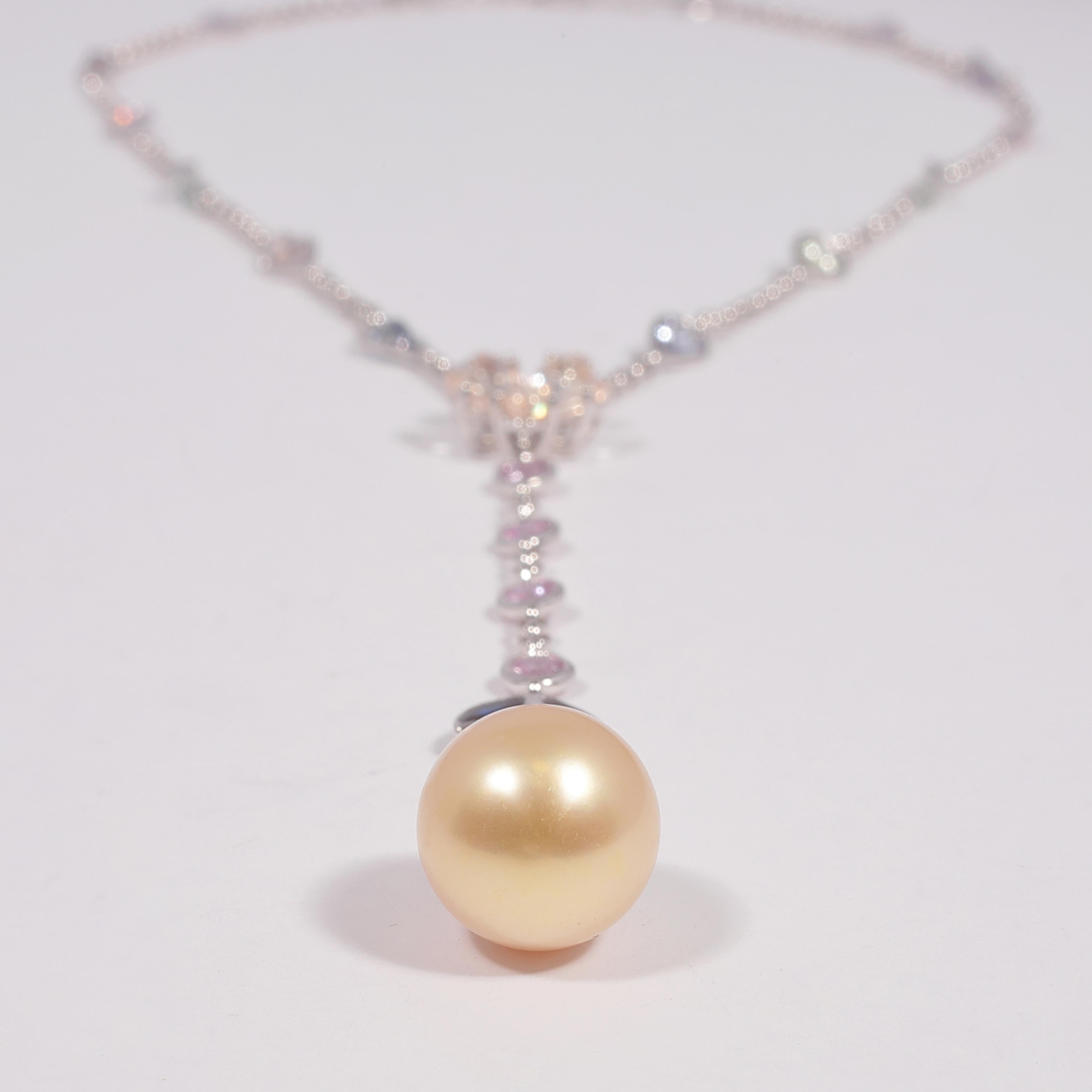 In 18 karat white gold, this necklace has a great swing to it!   For formal or casual occasions, this is a versatile piece.  The yellow South Sea pearl measures approximately 12.70 mm x 11.45 mm and is complimented by the array of gemstones set into