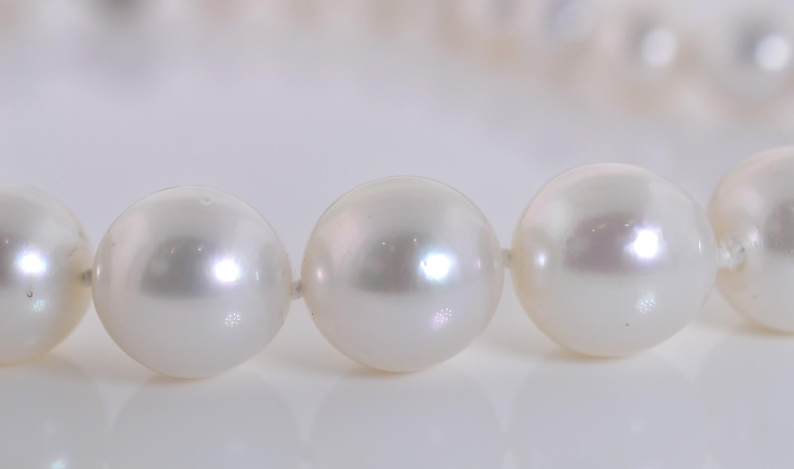 Luminous strand of  knotted large South Sea Pearls measuring between 12.12 to 15.06 mm.  The pearls are beautifully matched and are of a snow white luster, the strand is completed with a 14KT white gold filigree ball claps.  Lovely chic!