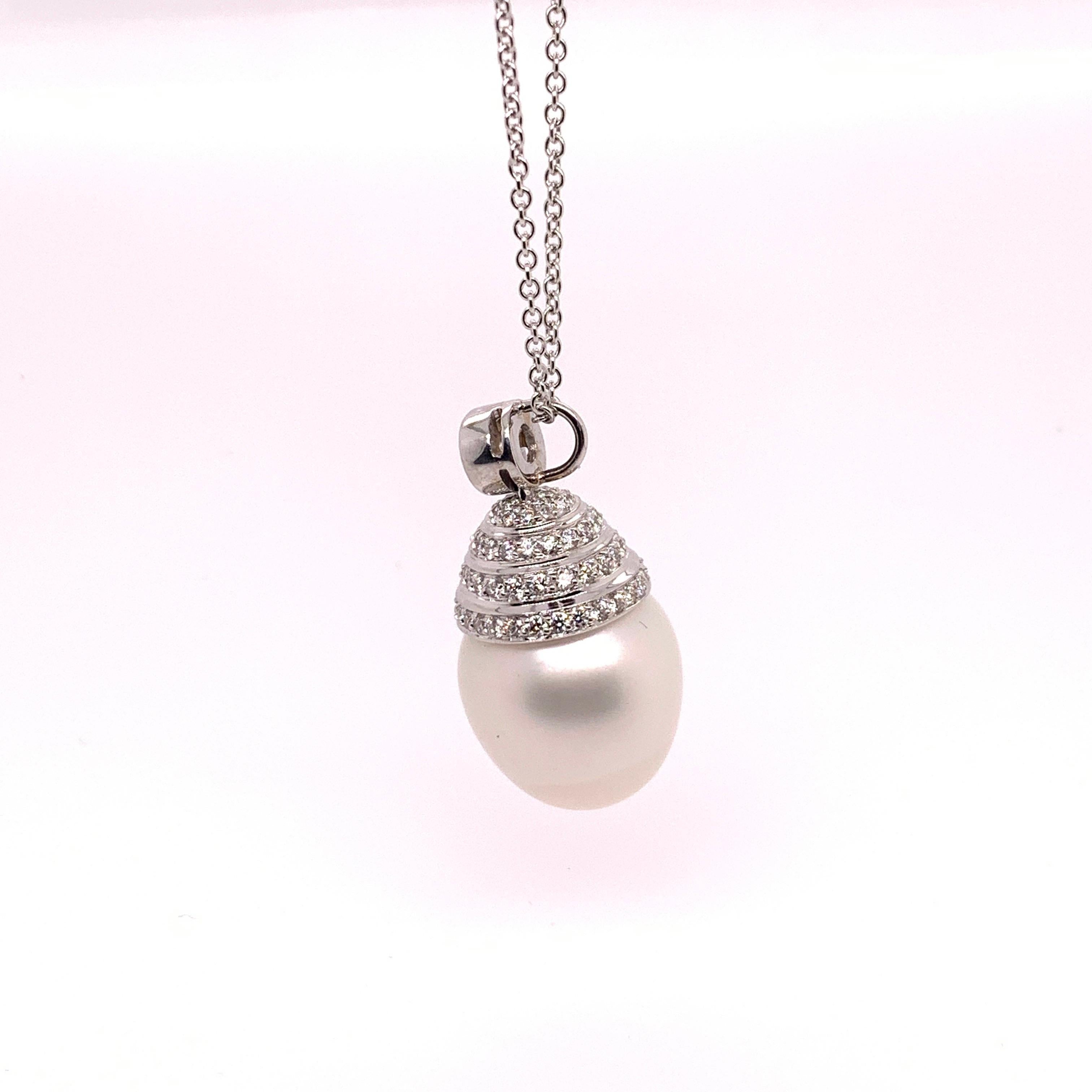 An 18k Gold Pendant set with 88 colorless Natural Round Brilliant diamonds. The pearl is 15mm and the piece weighs 11 grams. 