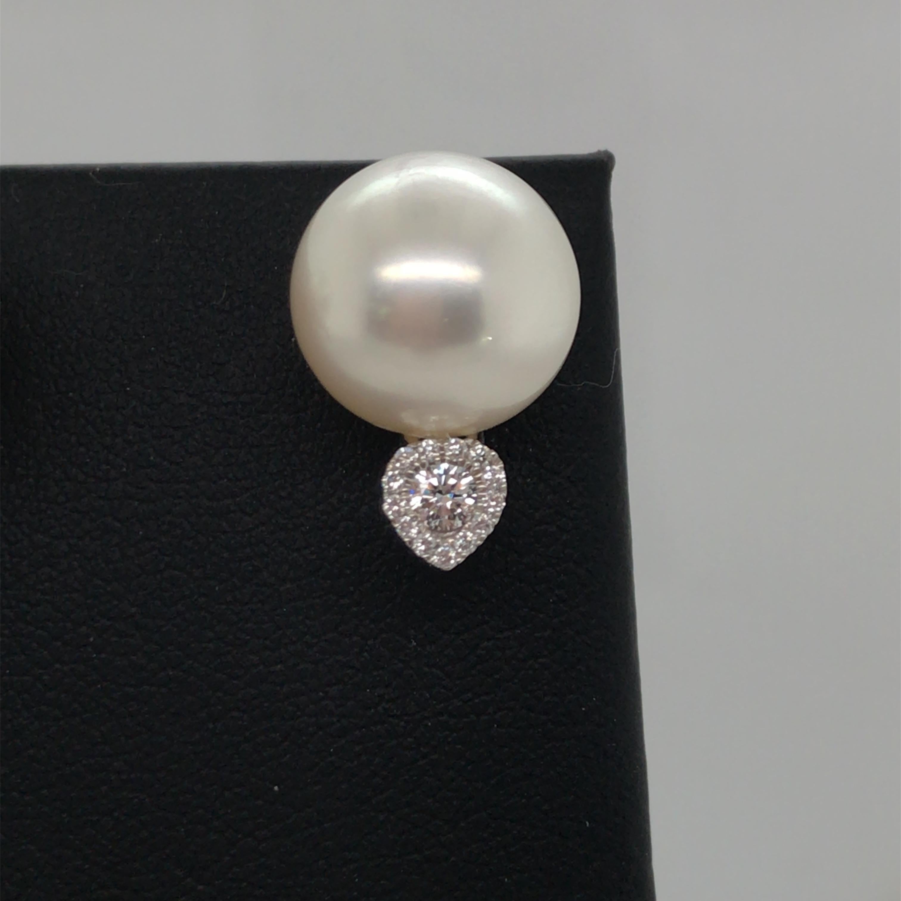 18K White gold earring featuring two South Sea Pearls measuring 12-13 mm and two round brilliants weighing 0.17 carats flanked with 26 round diamonds in a heart shape design, 0.10 carats.
Color G-H
Clarity SI