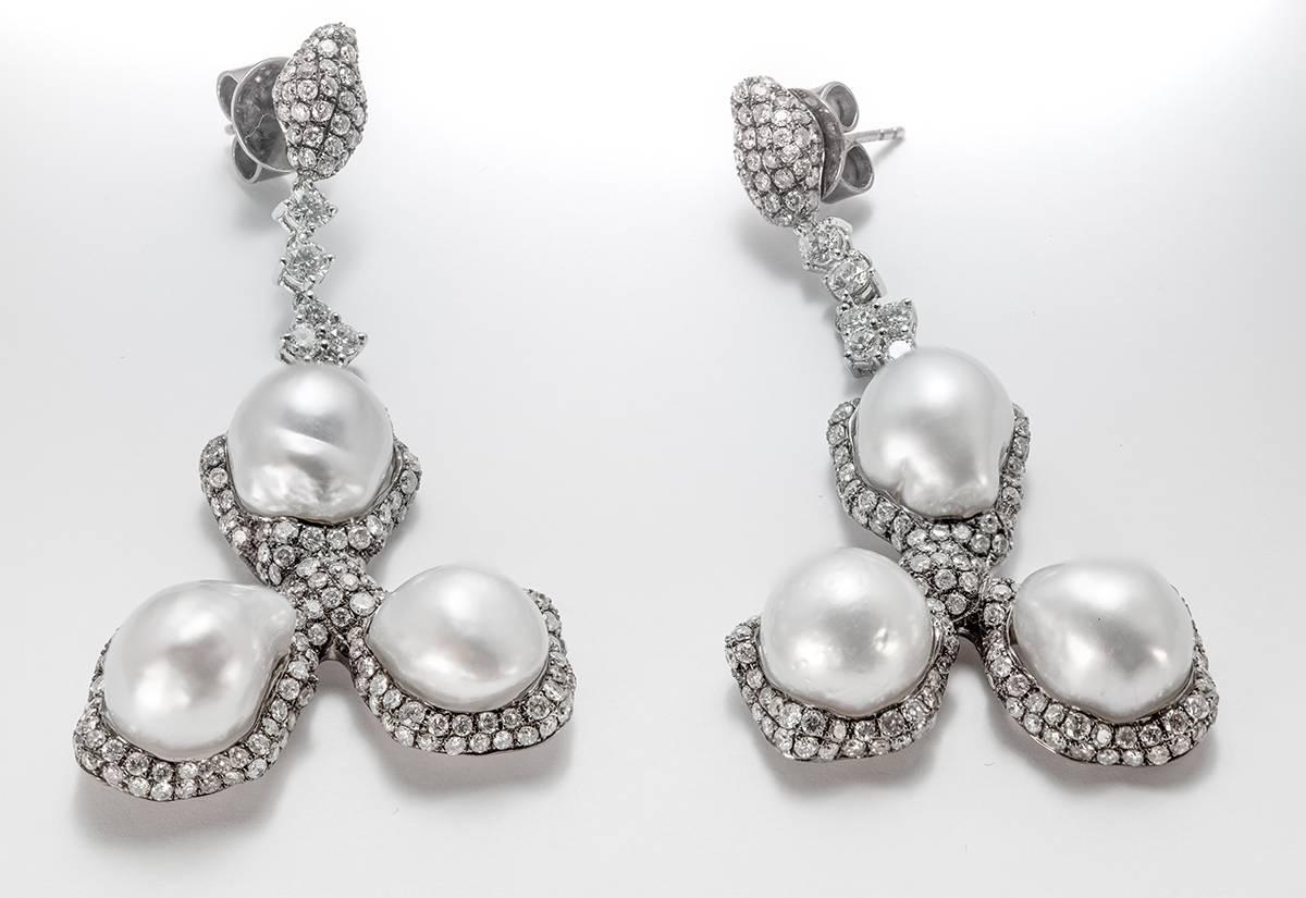  White Cultured Baroque South Sea Pearl Icy and White Diamonds of total weight 4.75 Carat H Color VS Clarity set in 18 Karat Blackened Gold Drop Earrings.
The Pearls 10 - 14mm have a high luster and Silver overtones. Perfectly made for pierced ears. 