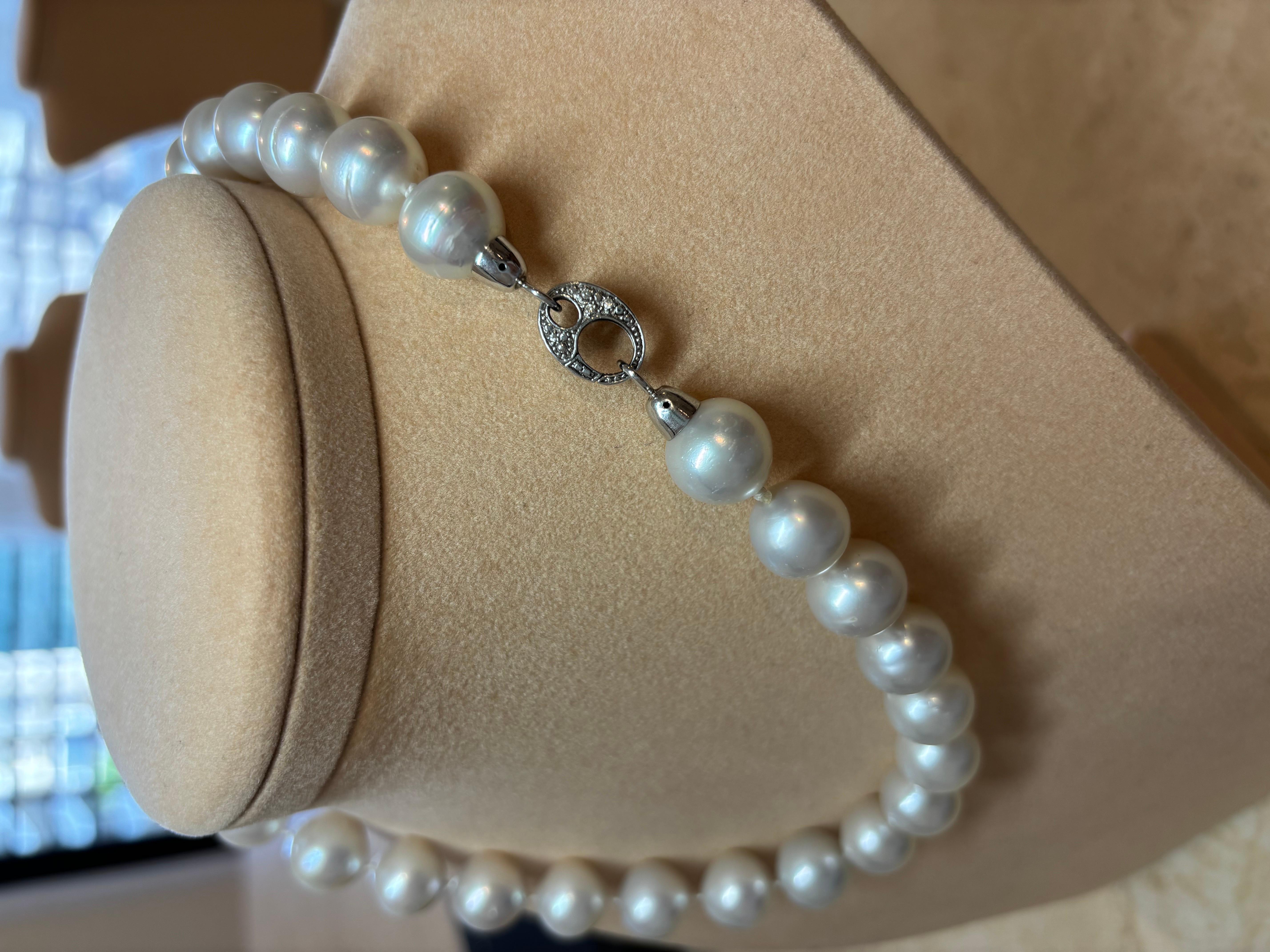 This exceptional necklace is strung with cultured White South Sea pearls, with an impressive size of 12mm - 15mm.

 It has a length of 49cm and features an 18K White Gold clasp closure set with natural diamonds.

The pearls are near round which is