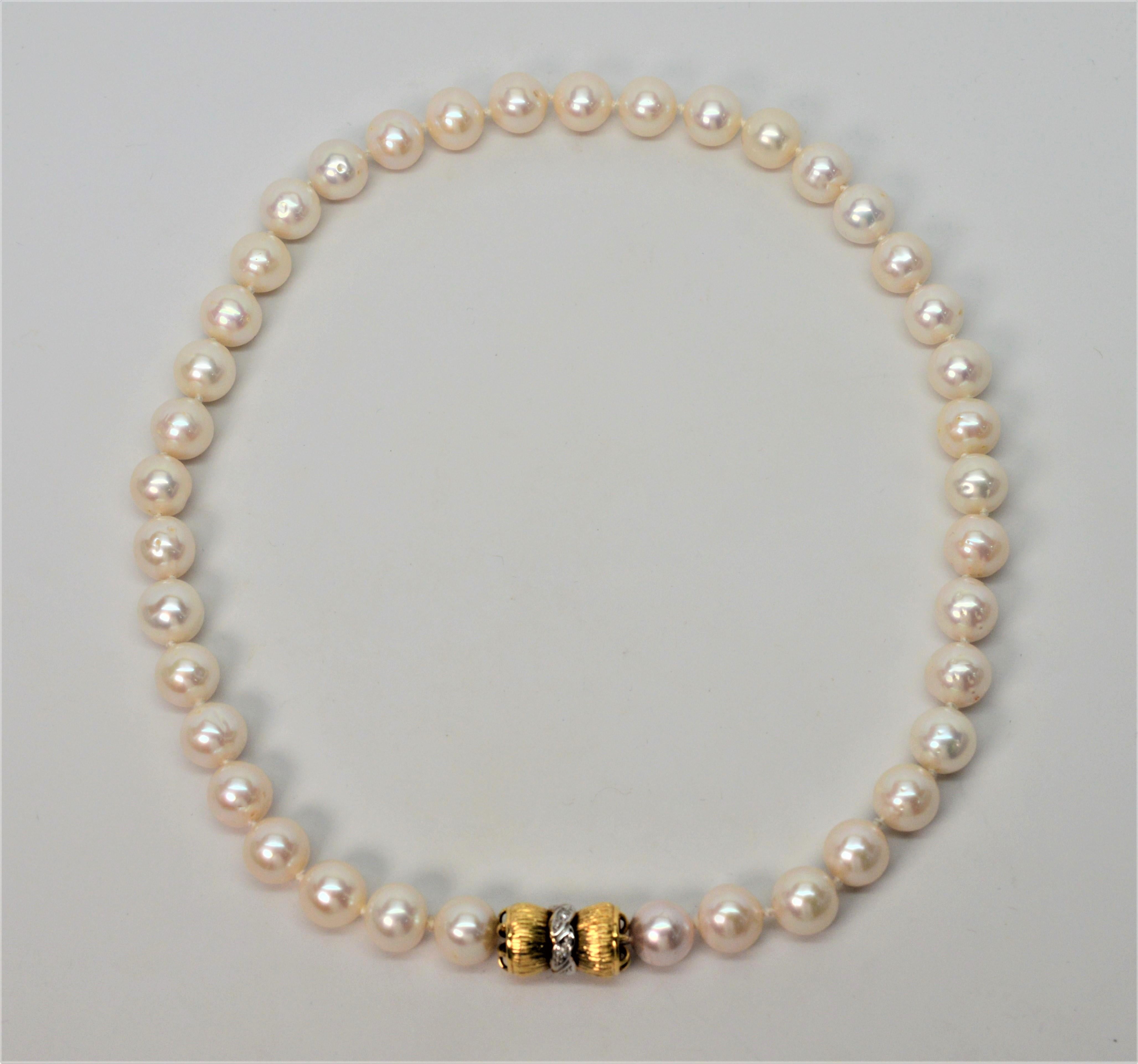 Beautiful white Akoya pearls create this classic and substantial strand with generous 9.75 x 10.25 mm Grade A cultured pearls.
Adorned with a sizable 3/4 inch fourteen karat 14K yellow gold bow clasp accented with diamonds can be worn as a front