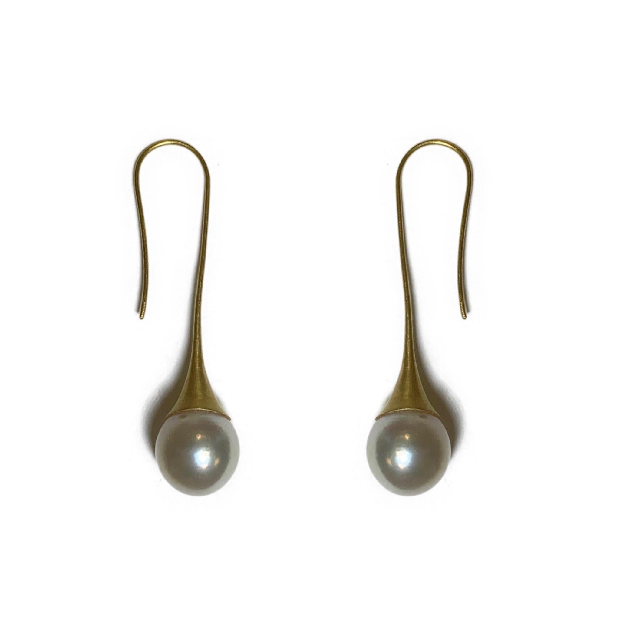 These elegant pearl drop earrings weigh 26.30 carats total. These ear wire earring are made of 18 Karat Yellow Gold and has a soft satin finish. 

A2 by Arunashi
South Sea Pearl on Medium Trumpet Drop Earrings
18 Karat Yellow Gold 
South Sea Pearls