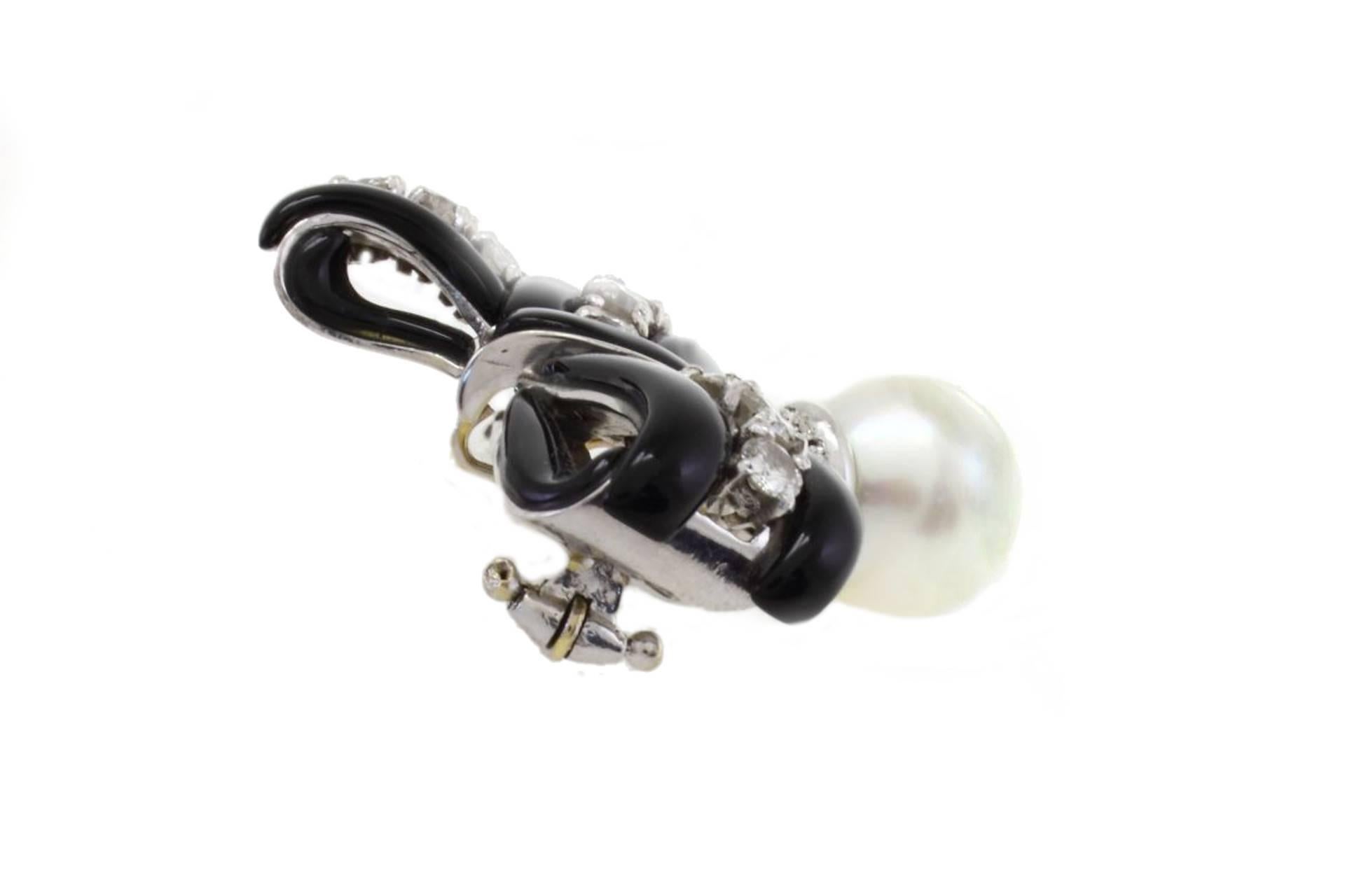 Retro South-Sea Pearl, Onyx, Diamonds, 14 Karat White Gold Ribbon Brooch. For Sale