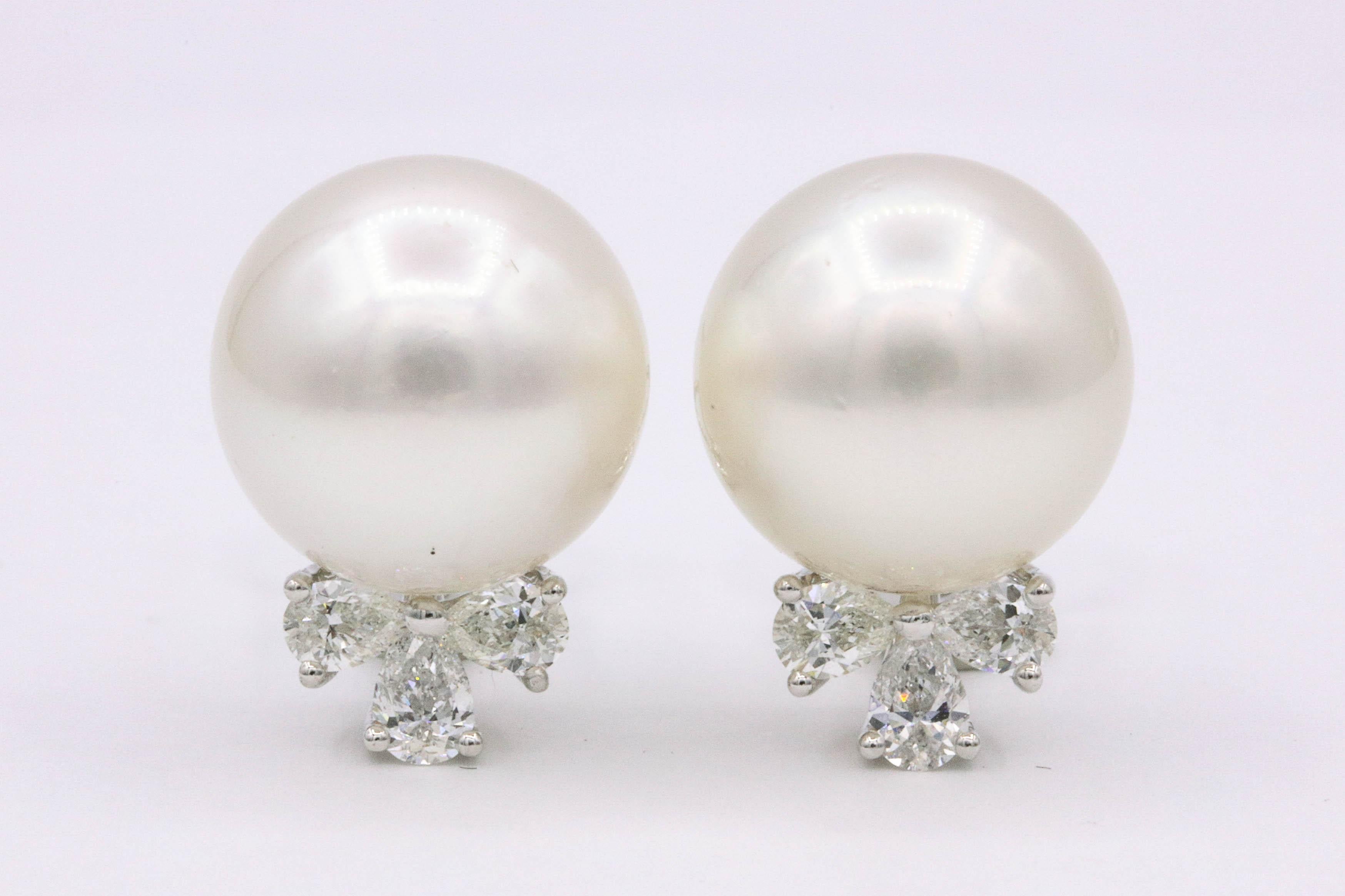 Elegant South Sea Pearl earrings featuring 6 pear shape diamonds weighing 0.85 carats in 18k white gold. 
South Sea Pearl: 13-14 mm
Color G-H
Clarity SI