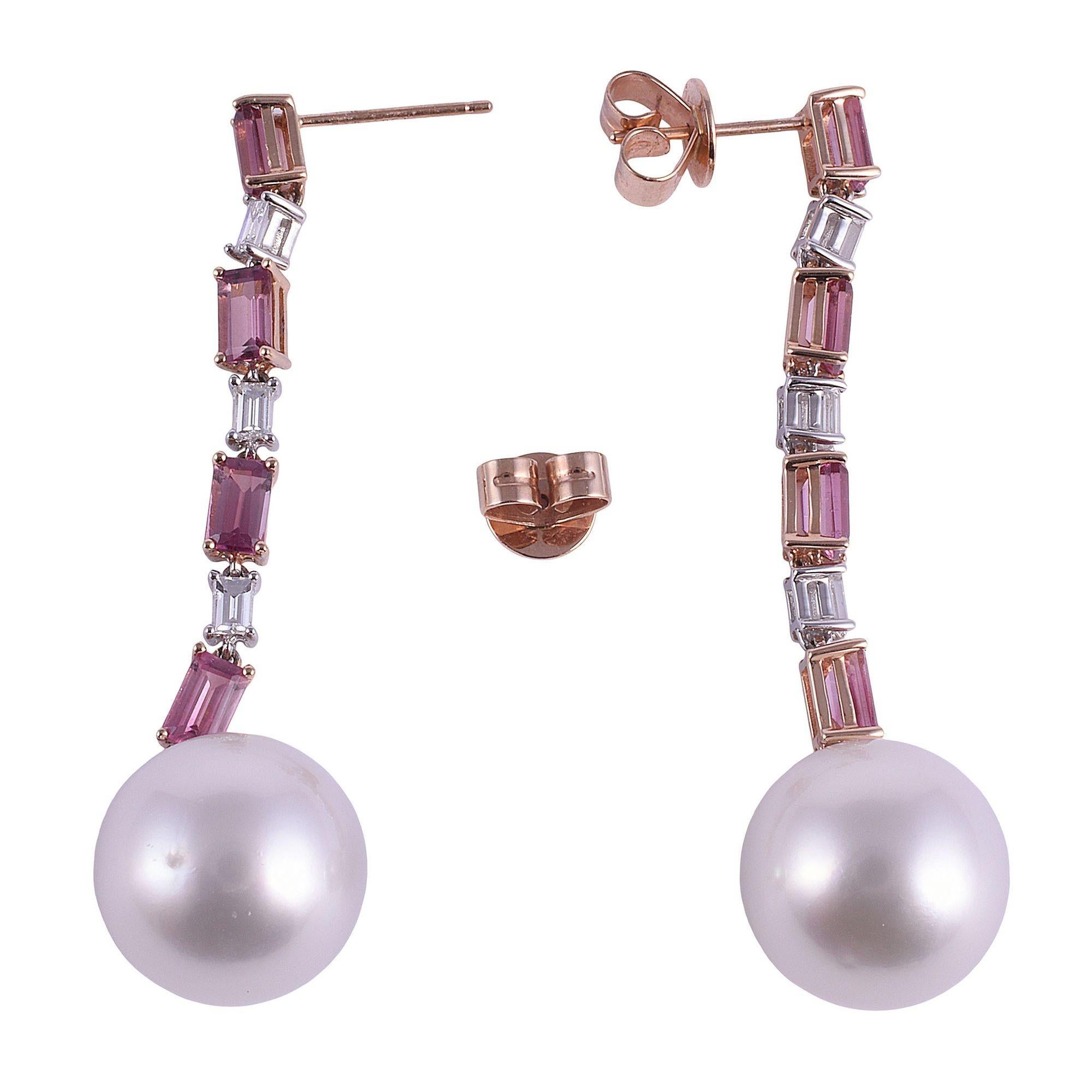 Estate South Sea pearl pink tourmaline 18K rose gold dangle earrings. These estate earrings are crafted in 18 karat rose gold featuring 13.5mm cultured South Sea pearls suspended from a line of alternating pink tourmalines and diamonds. There are