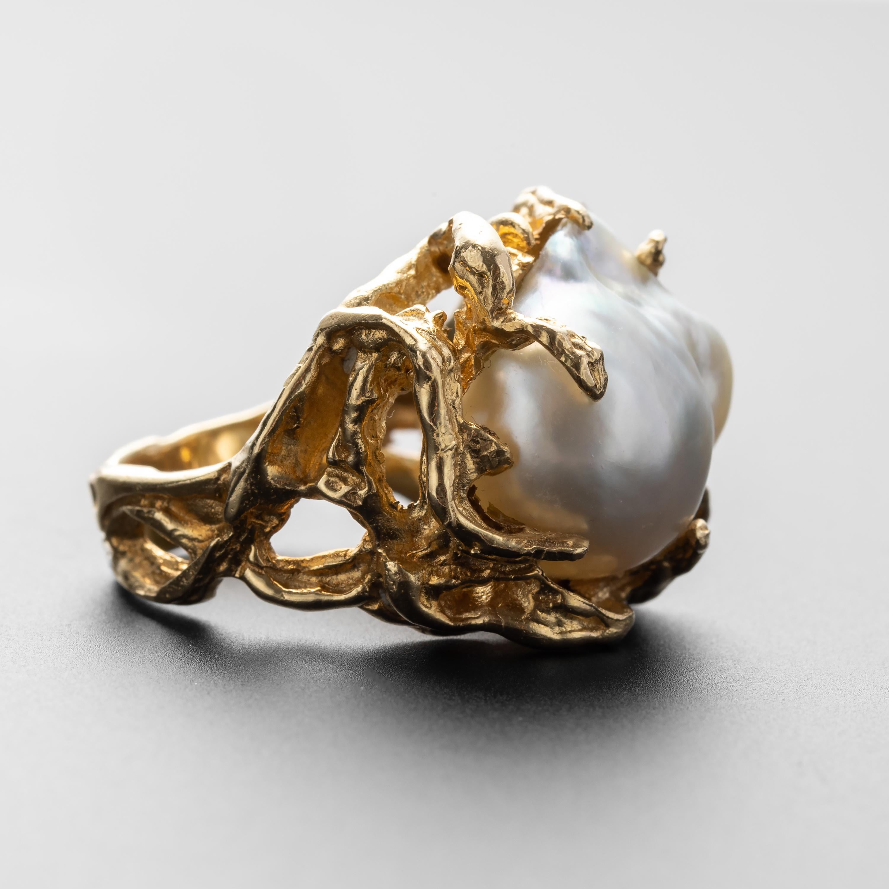 A gorgeous, bold, and unusual cocktail —or anytime— ring that features an enormous GIA-certified South Sea pearl. 

The 14K yellow gold setting suggests a tangle of seaweed into which the South Sea pearl has been entangled with tendrils of gold