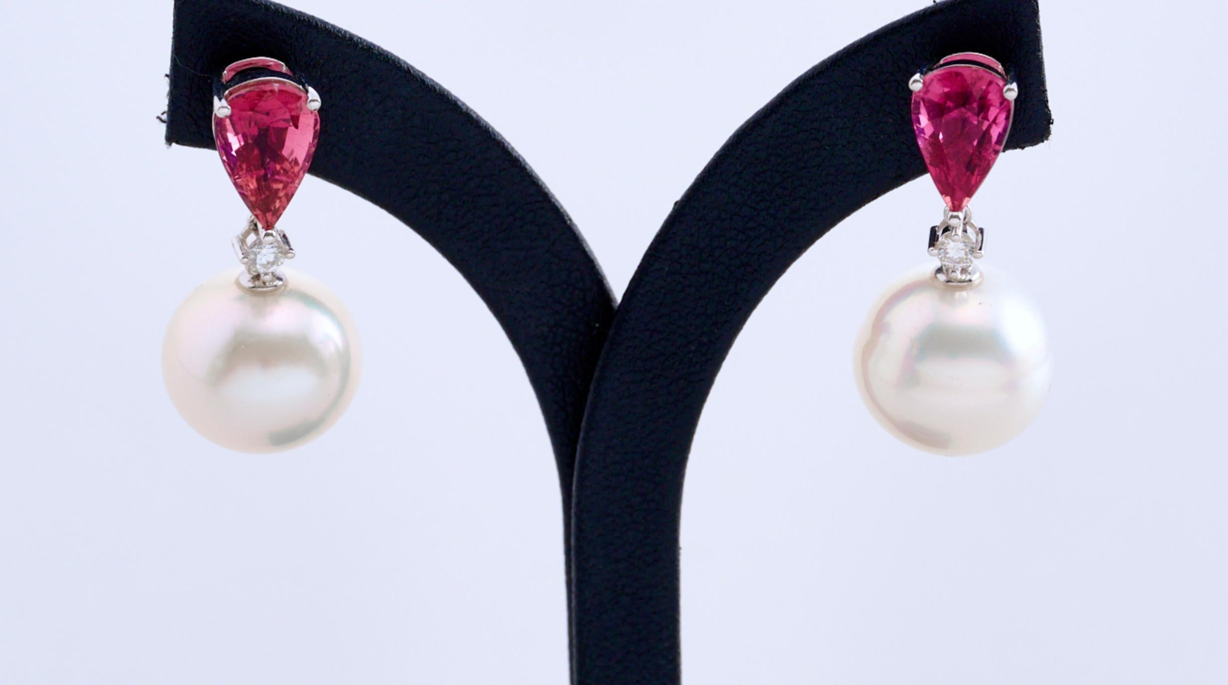 A pair of Rubellite, White South Sea Pearls and Diamond Earring in 18K White Gold. This is our signature Pearl Earring design, Main Stone suspended by a single Pearl. on top of that the round Brilliant cut Diamond in the middle adds more fire and