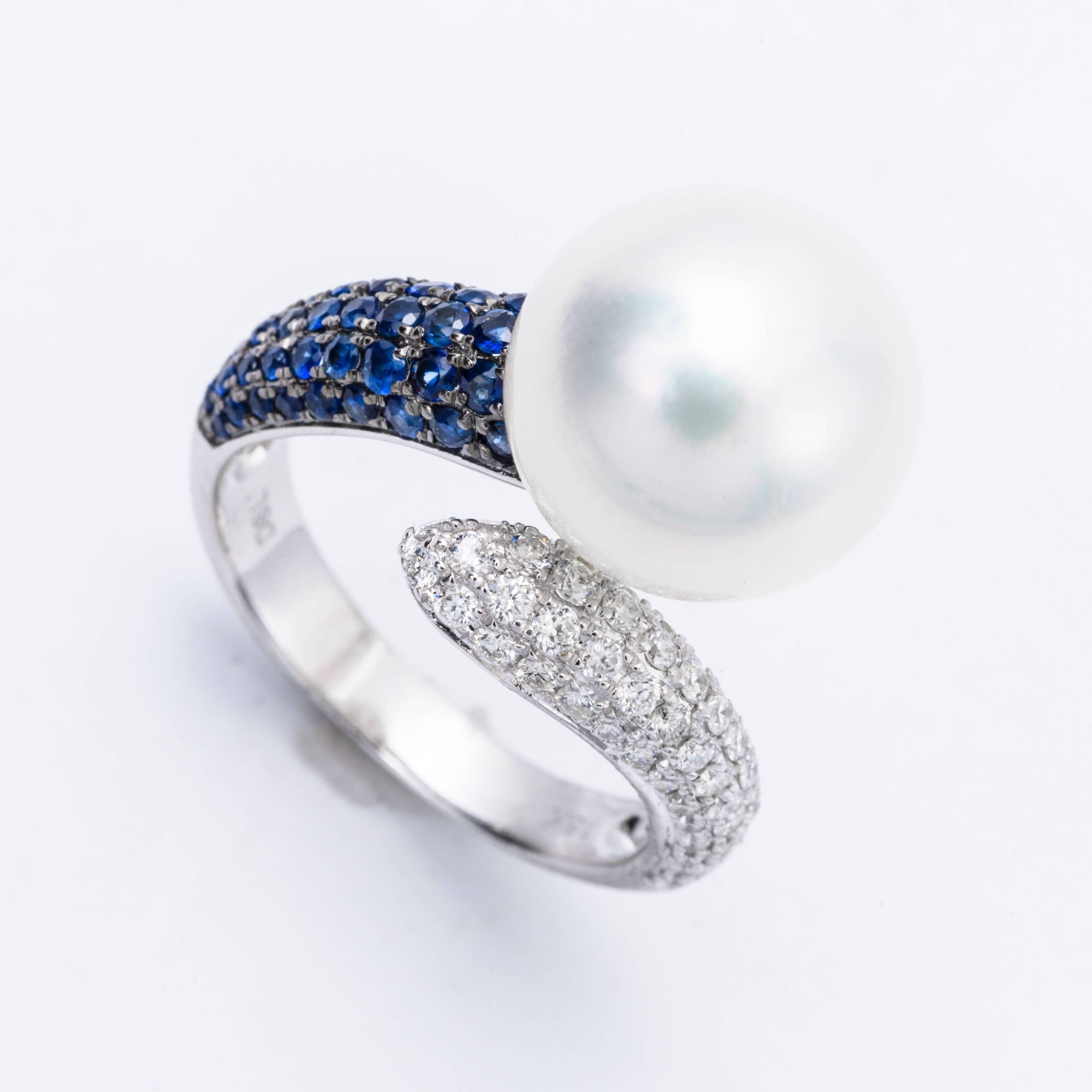this exceptional ring features: 18K White gold
Sapphire weight: 0.48 Carats
Diamonds Weight:: 0.46 Carats
South Sea Pearl; 12-13 mm 
Ring size: 6.5 We Re size free of charge