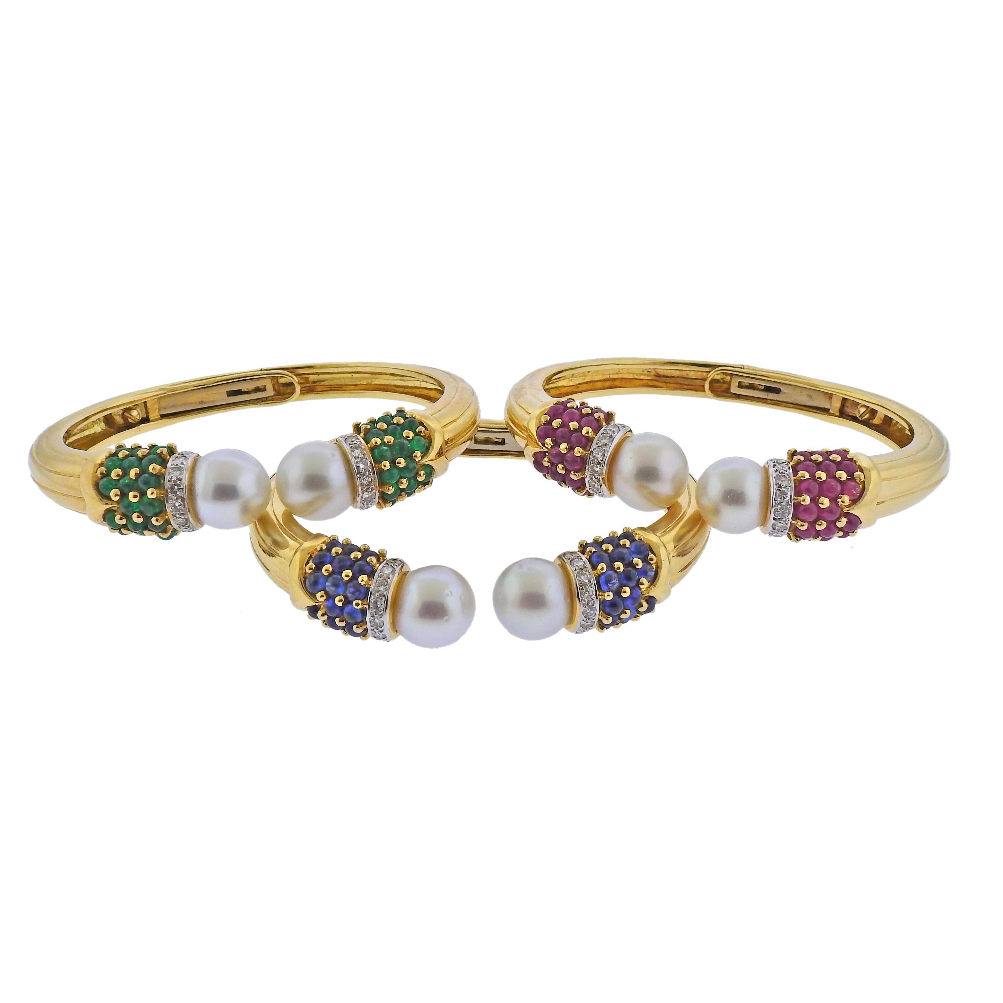 Set of three bangle bracelets in 18k yellow gold, set with emeralds, rubies, sapphires approx. 1.08ctw in H/VS-SI diamonds total and 11.2-11.7mm South Sea pearls. Each bracelet will fit approx. 6.75-7