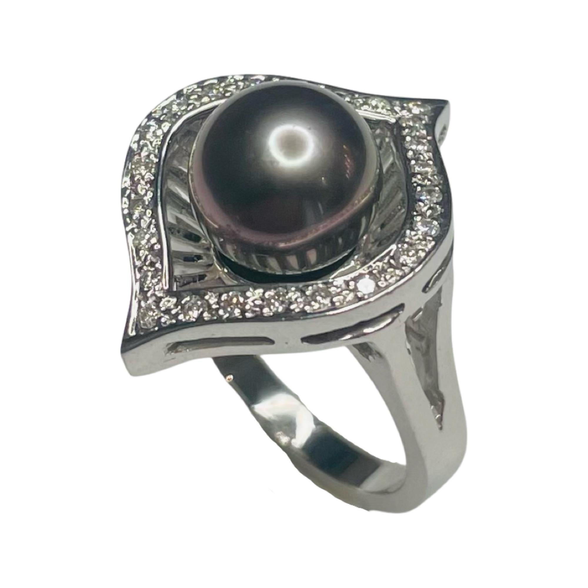 South Sea Pearl 18K White Gold Natural Color Cultured Black Tahitian Pearl Ring. The pearl is 9.65 mm. The pearl is round with slight blemishes and high luster. This ring has 0.25 carats of full cut round brilliant diamonds.  They are of VS clarity