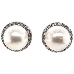Clous d'oreilles 18 carats en perles des mers du Sud avec halo de diamants
