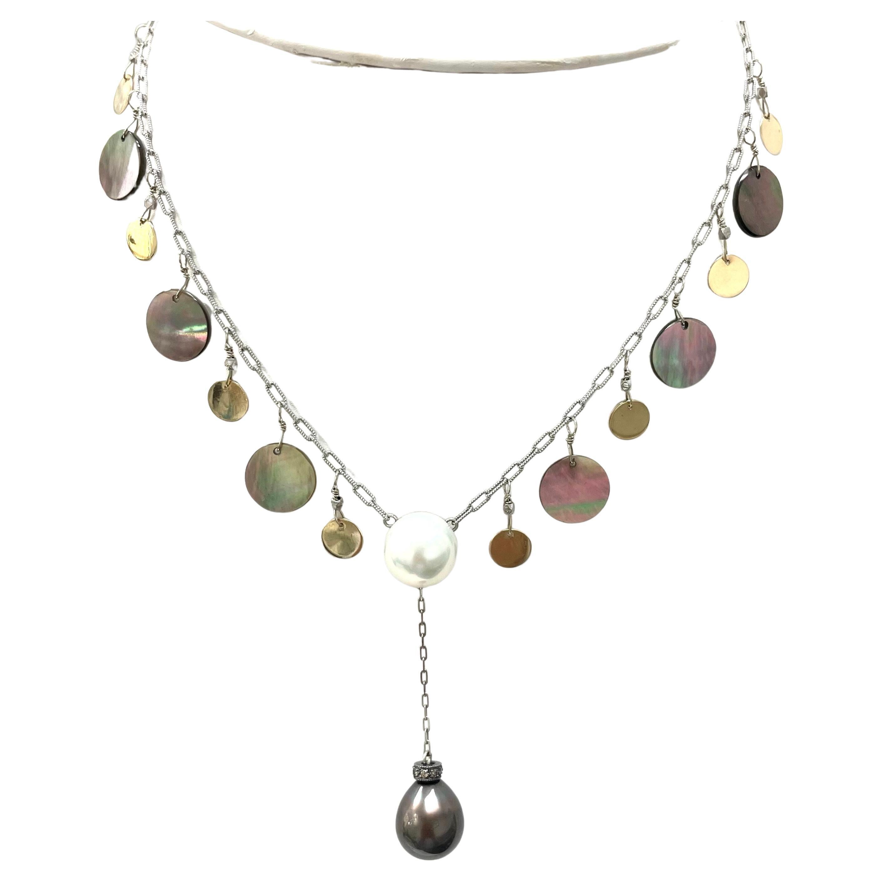 Description
Lovely, feminine combination of rare iridescent Tahitian Mother of Pearl and 14k yellow gold discs with a large white South Sea Pearl centerpiece and a rare jet black Tahitian drop on a 14k white gold chain.
Item # N1664
Check out