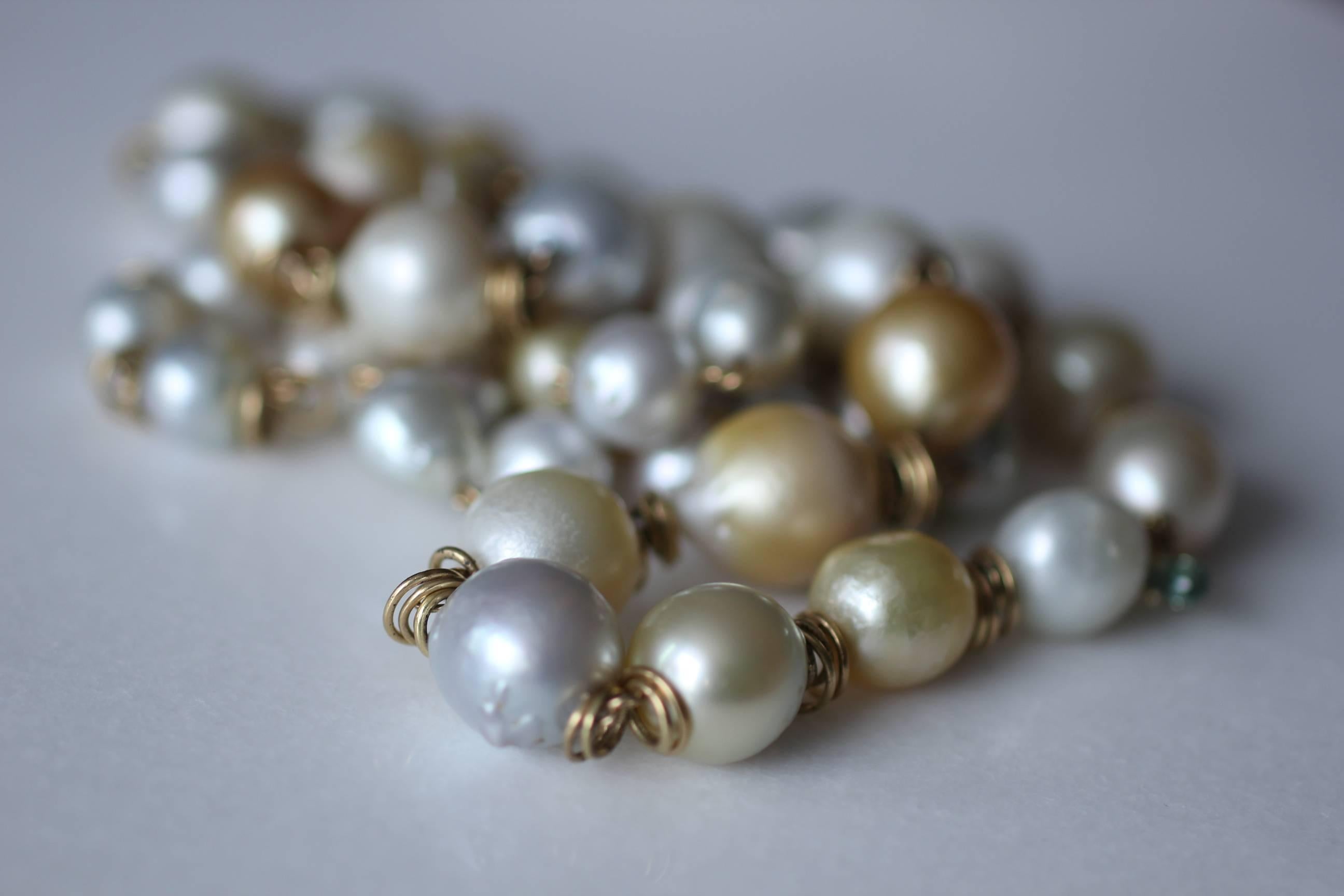 Sunlight Pearl Necklace is a beautifully versatile beaded link necklace. Bright lustrous white and golden baroque pearls ranging in size 10mm-17.5mm are wrapped in 18k gold and separated by 18k gold links. The necklace is terminated in 18k gold