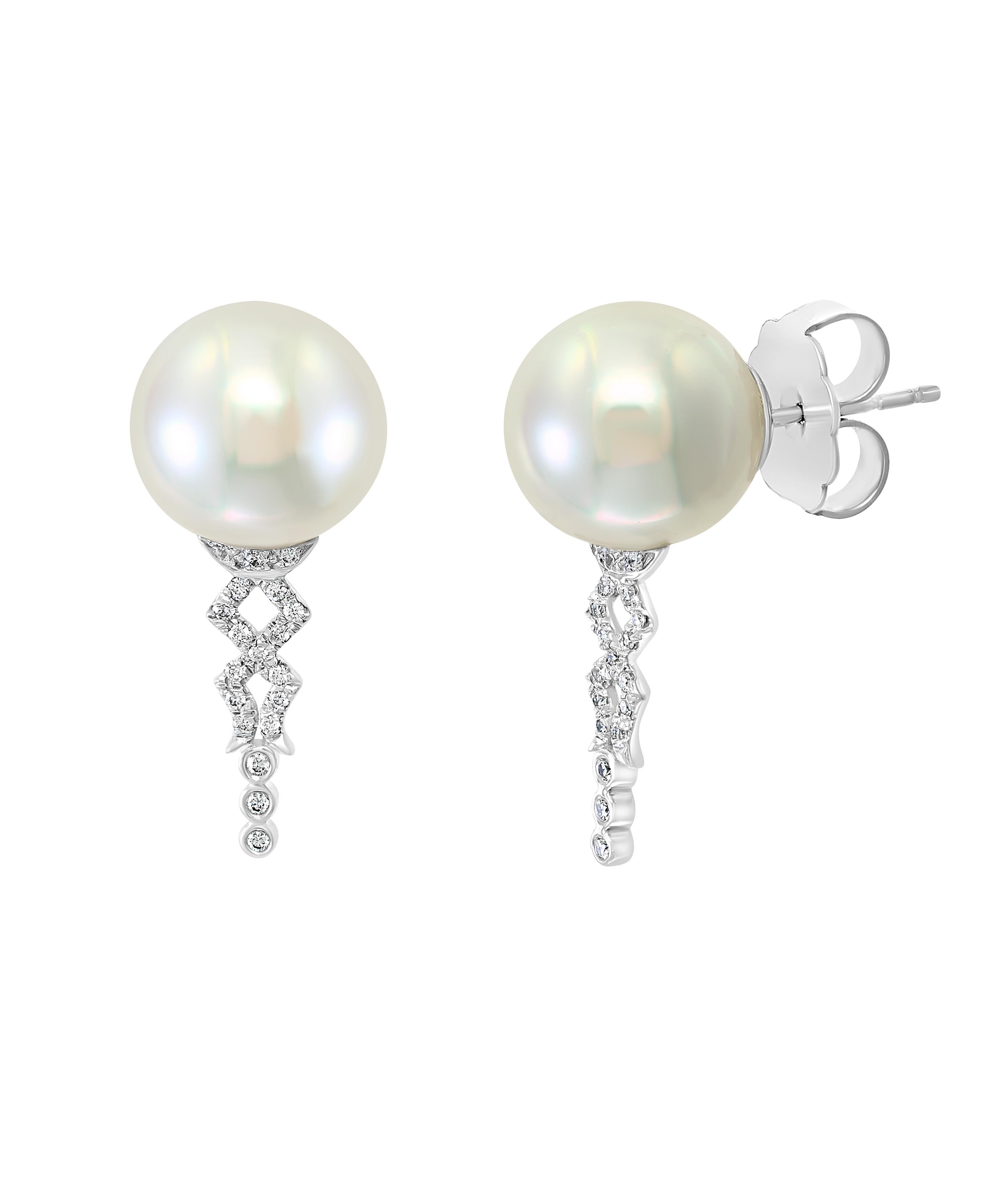 These elegant Diamond and Pearl earrings feature South Sea white round cultured pearls gracefully accentuated by diamonds set in white gold. The classic design of these earrings is perfect for the working woman or for an evening out on the town.
-