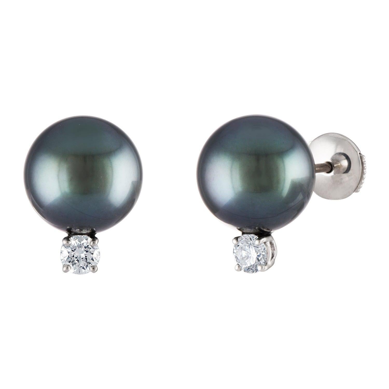These classic South Sea Tahitian pearl earrings feature round 10.5mm pearls atop 0.20 total carats of diamonds. The earrings are set on 14 karat white gold. 
Perfect for weddings, anniversaries, birthdays and graduations. Symbolizing purity and