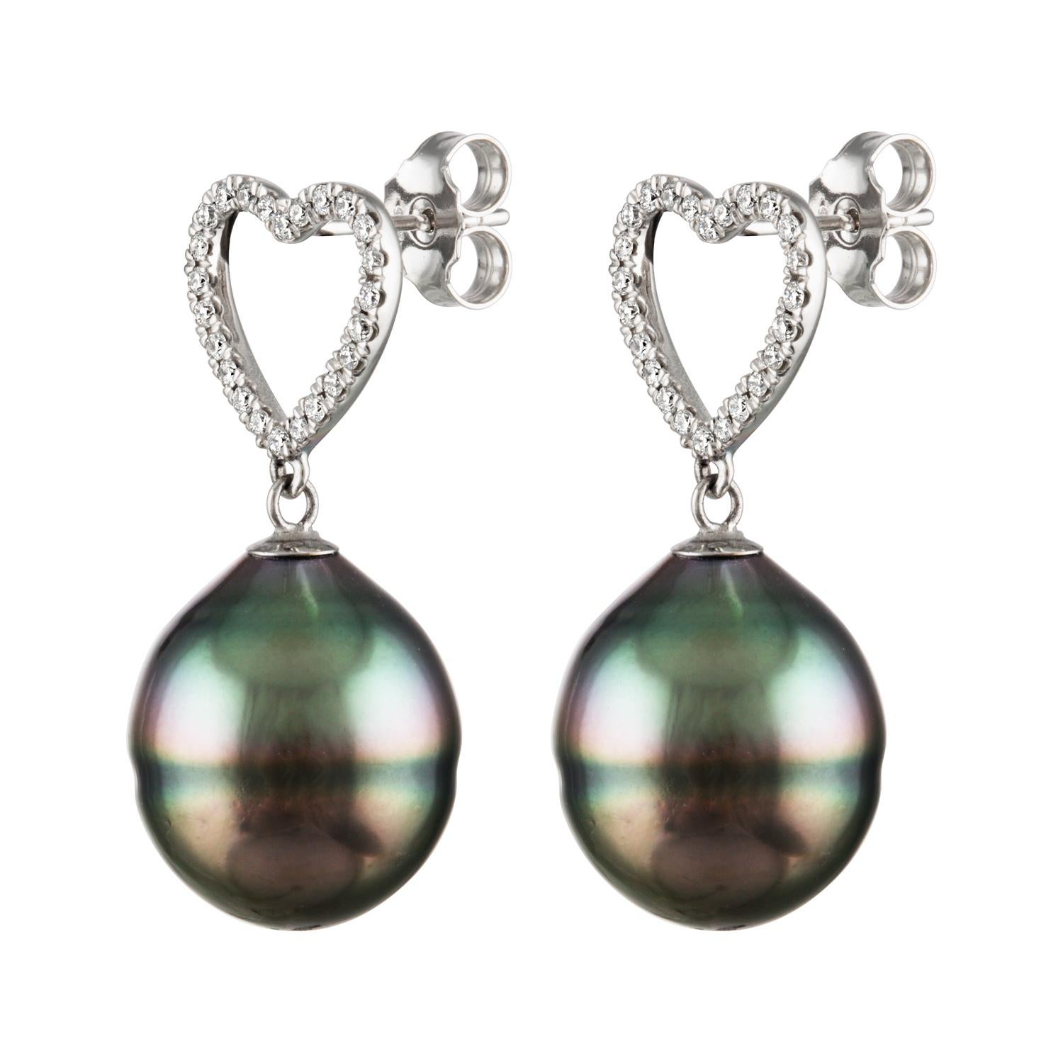 These earrings feature beautiful South Sea Tahitian baroque cultured pearls set on 14K white gold. 
These Tahitian pearls from French Polynesia measure 13.8x16mm and hang from White Gold heart shapes set with 0.36 carats of diamonds total.
These
