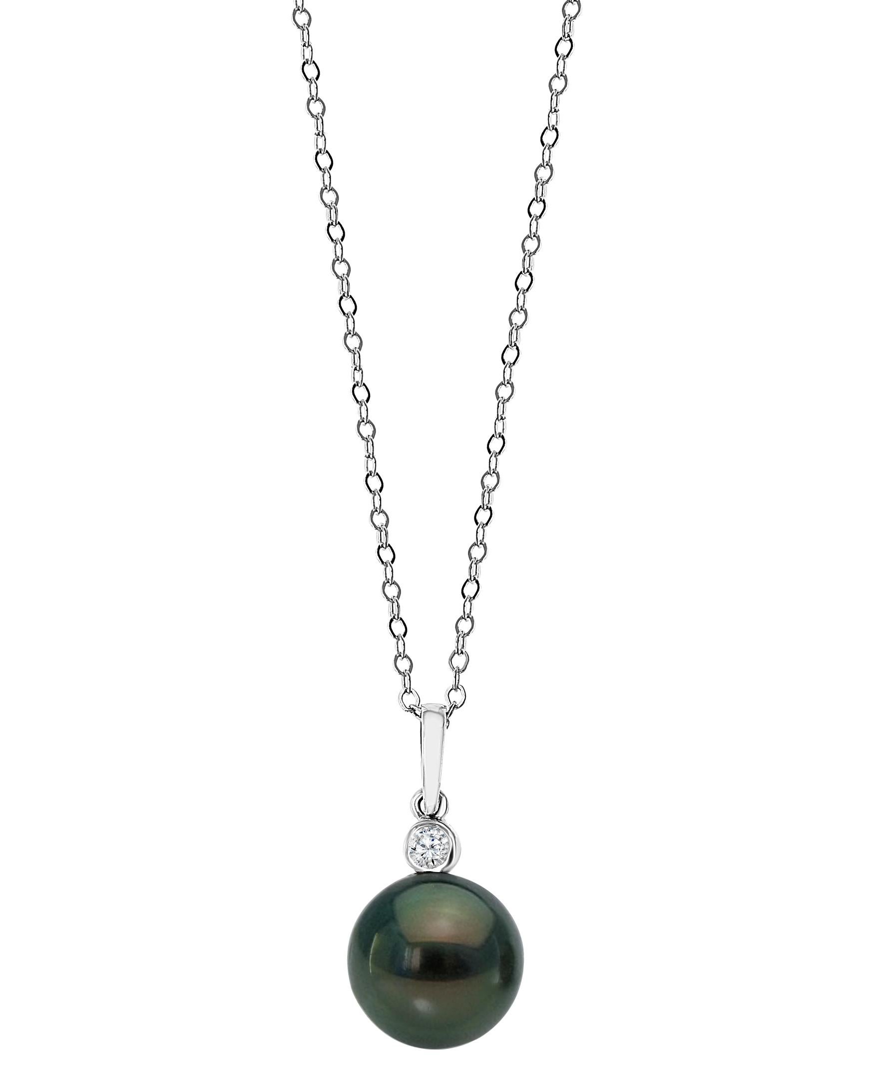 This iridescent South Sea Tahitian cultured round pearl dangles beneath a diamond set in 14K white gold. The pearl measures 8-9mm and there are 0.04 carats of diamonds. The pendant hangs from a 14K white gold adjustable chain with a maximum length