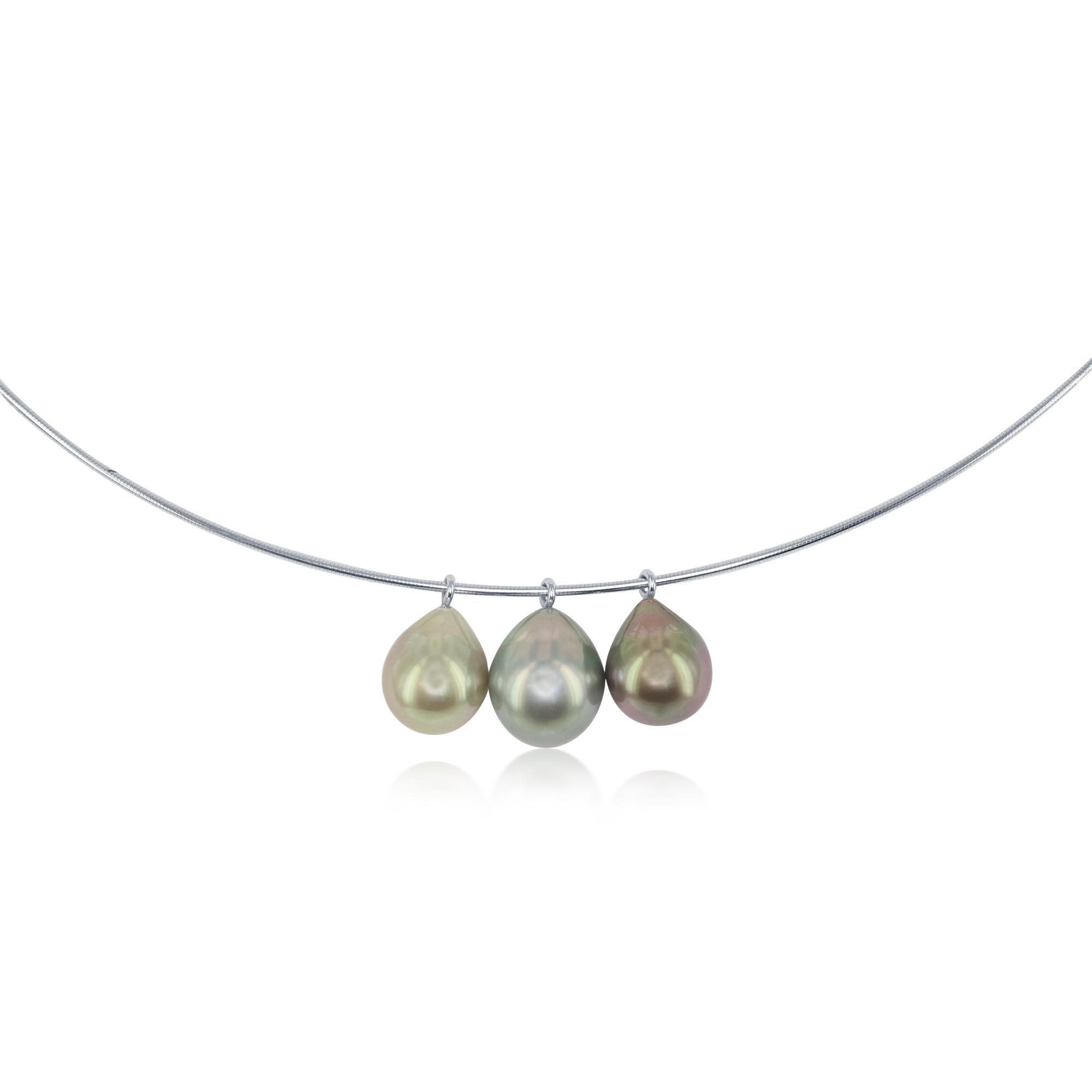 These three South Sea Tahitian cultured drop pearls are varying shades of pistachio green. The pearls are 9.5-10mm and dangle from an 18 karat white gold wire. This gorgeous necklace offers the perfect pop of color and touch of elegance to any