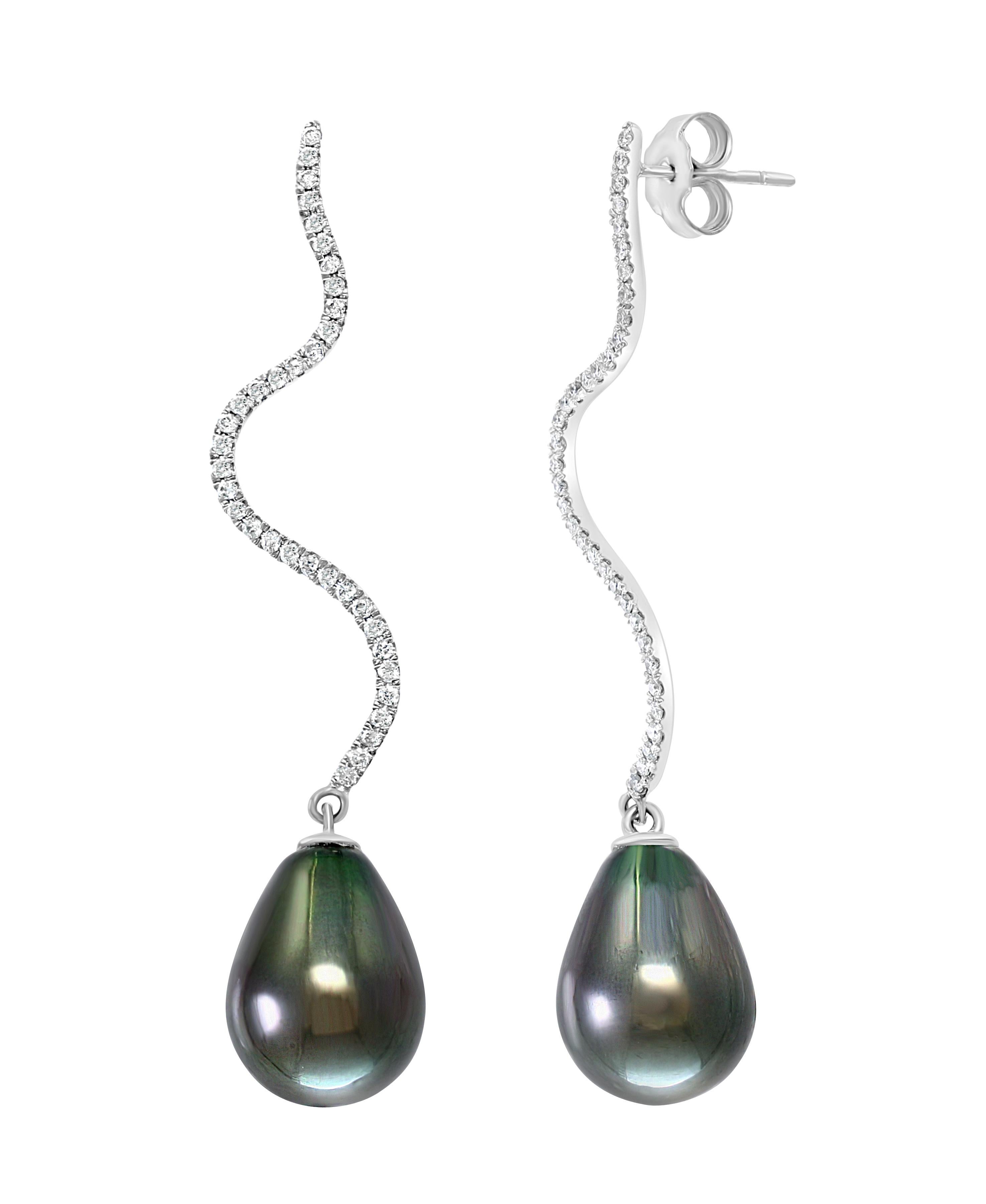 These elegant Diamond and Pearl earrings contain South Sea Tahitian cultured drop pearls dangling gracefully from white gold and diamonds. A perfect complement to any evening apparel.
- 14K White Gold.
- 0.53 Carats of Diamonds. 
- Pearls measure