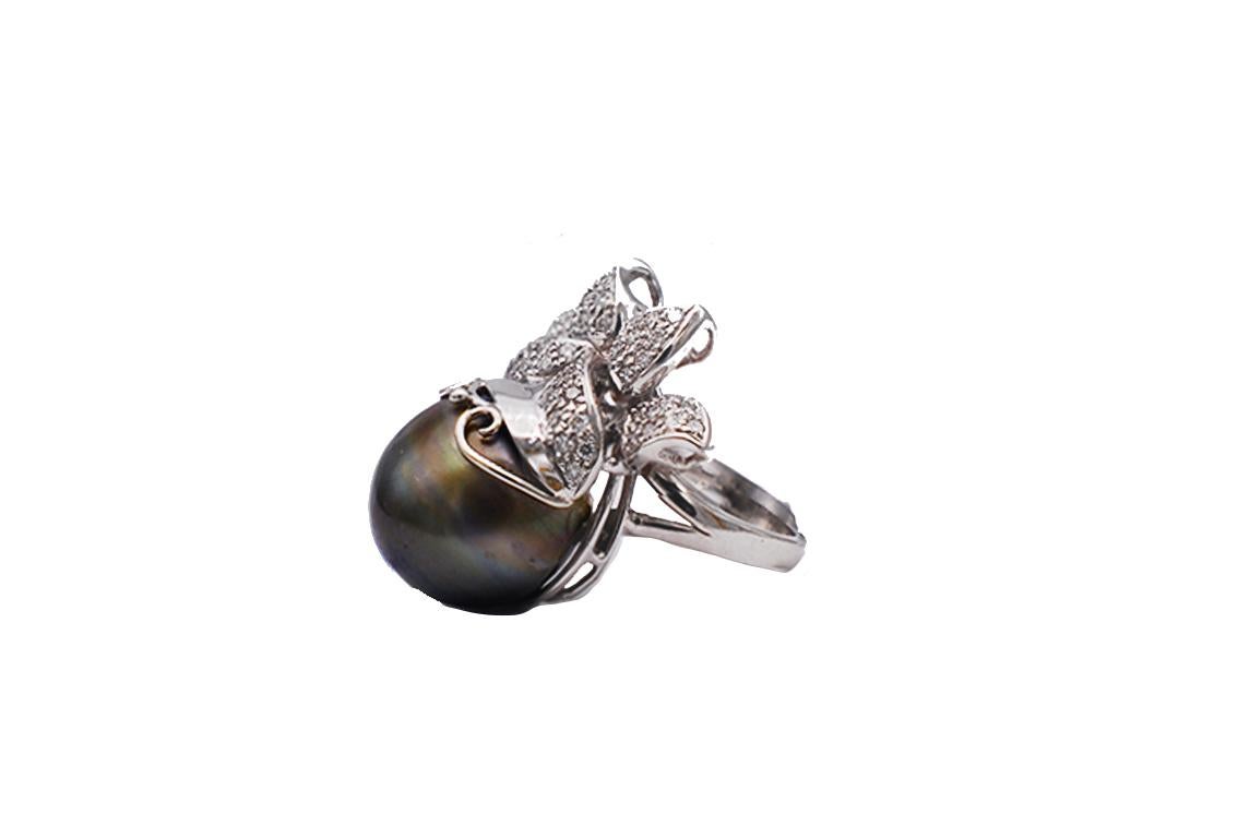 Fine lustrous, gray Tahitian pearl ring measuring 14.85 MM 
Diamond crown consists of VS Clarity melee with a total weight of 1.50 Carat Diamond Ring. 
The pearl is a very fine gray color with very little blemishes. The height of the pearl is 16.30