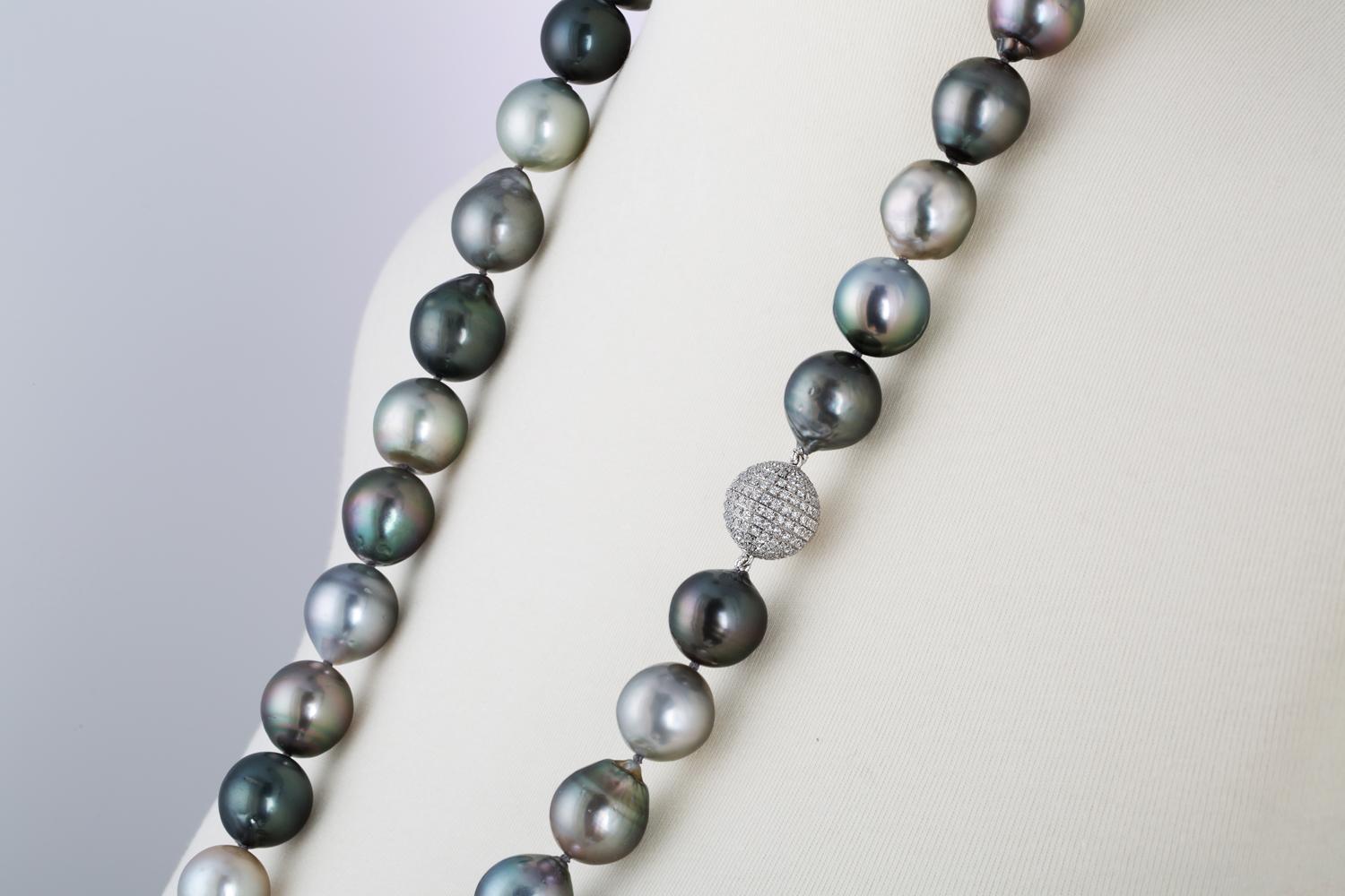 This necklace consists of fine quality South Sea Tahitian multi-colored Baroque cultured pearls measuring 15x17.7mm. The pearls have very high luster in silver, green, bronze, grey and charcoal hues with very few blemishes. The necklace measures 36