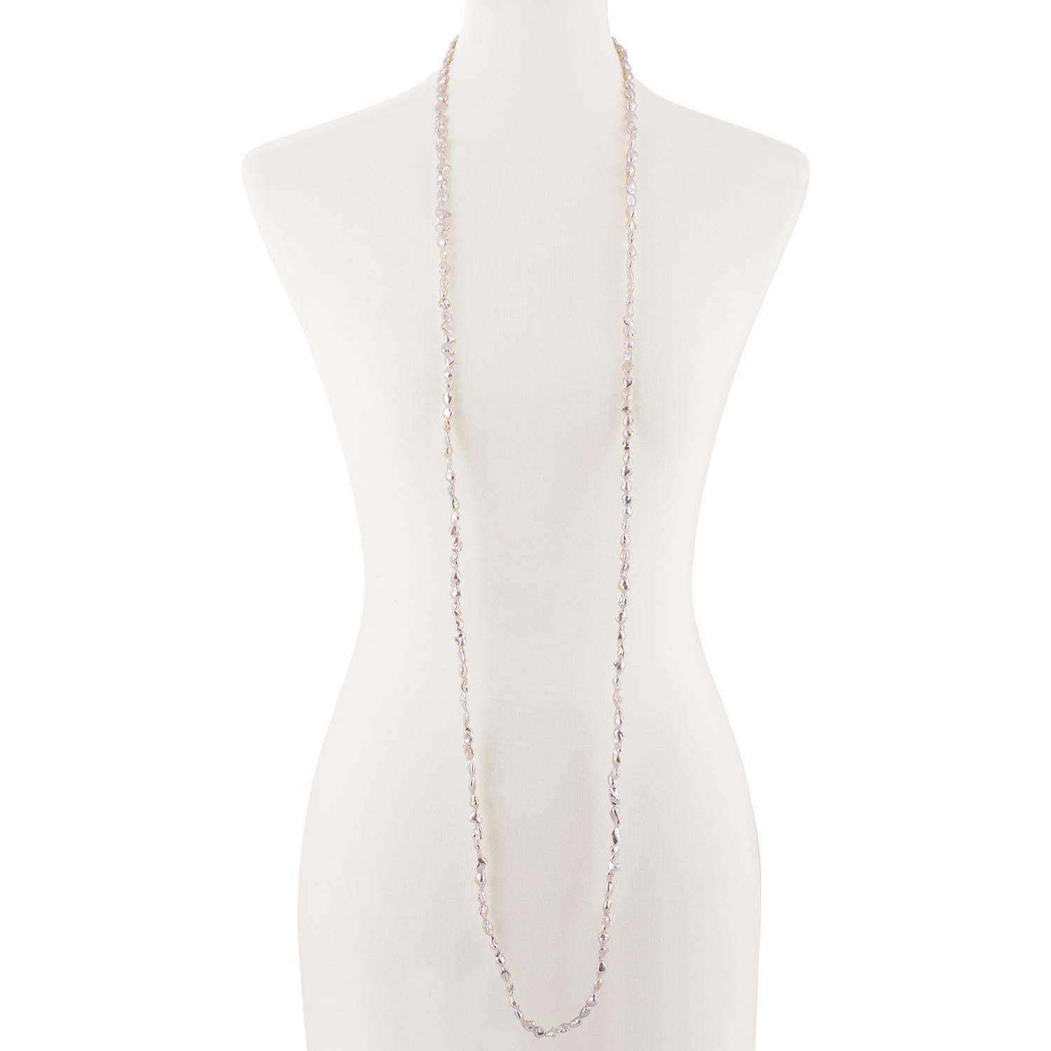 This pearl rope necklace features South Sea white keshi cultured pearls strung with knots to 61 inches in length. The pearls measure 6x8mm and there are 160 pearls total. This necklace can worn many different ways by doubling, tripling or even