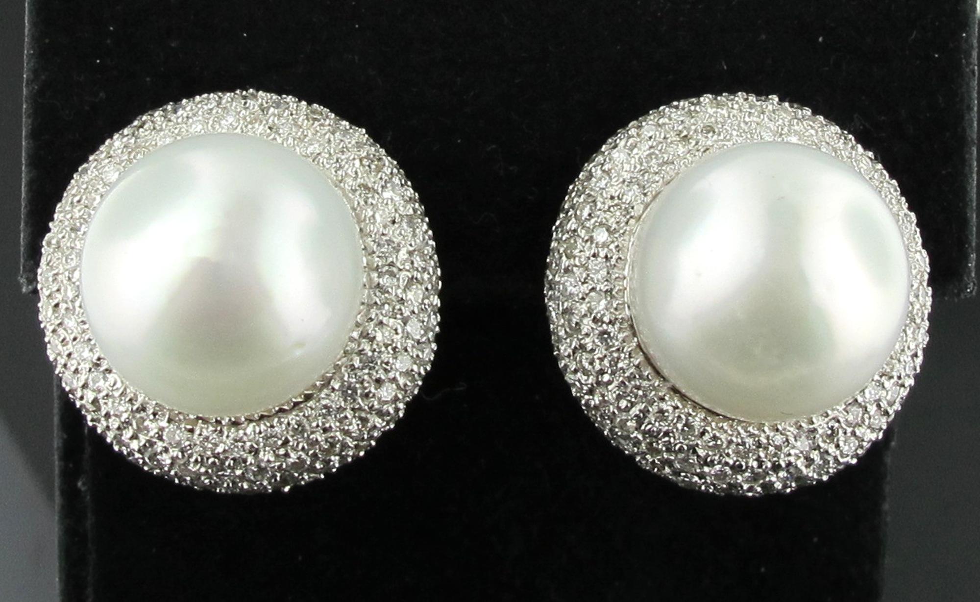 Set in 14 karat white gold are two south sea 13.6 millimeter pearls surrounded by approximately 2 carats of pave diamonds on each earring for a total diamond weight of approximately 4.00 carats. The pearls have a high lustre. 