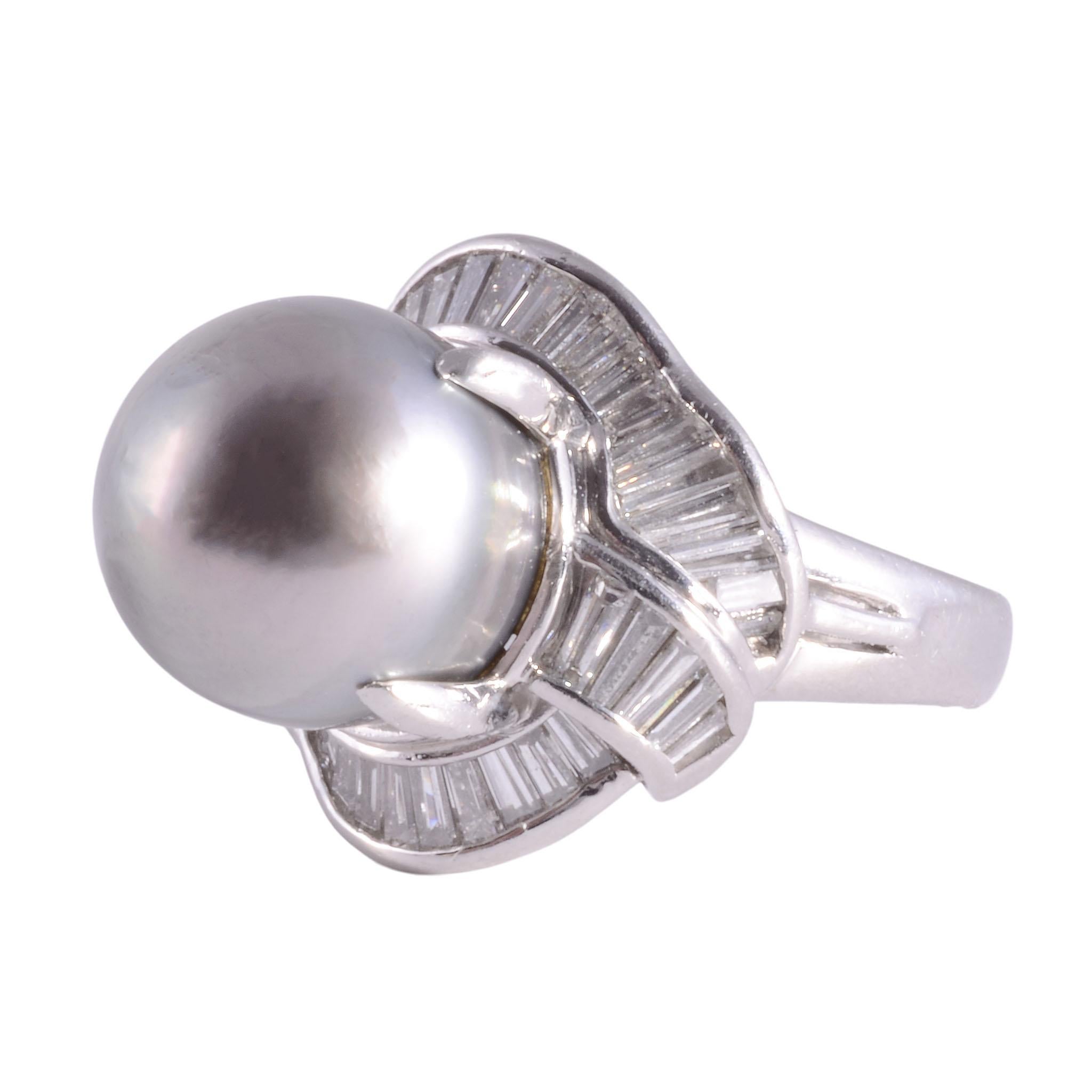 Estate South Seas pearl platinum ring. This platinum ring features a 15-15.5mm South Seas pearl center that is a fine medium gray with a pinkish overtone. It is accented with 1.16 carat total weight of fine cut baguette diamonds having VS-SI clarity