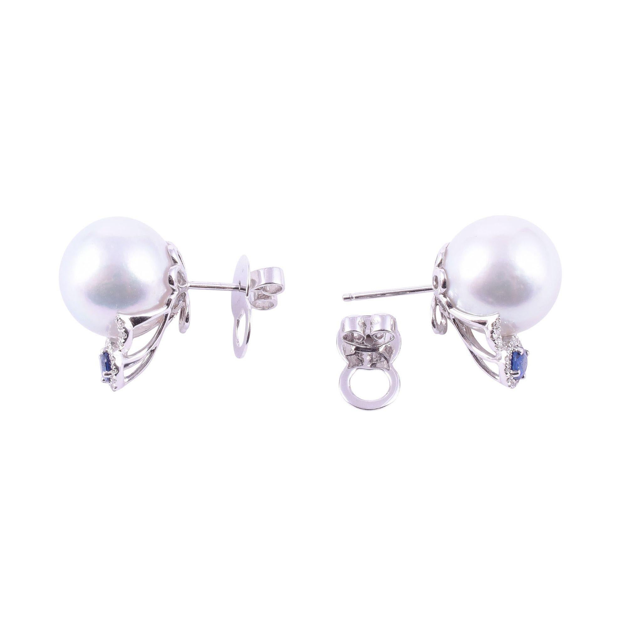 Estate South Seas pearl & sapphire 18KW earrings. These custom made 18 karat white gold earrings feature fine quality cultured South Seas pearls measuring 13.42-13.47mm with a slightly off round shape, silver white color, very good luster, and