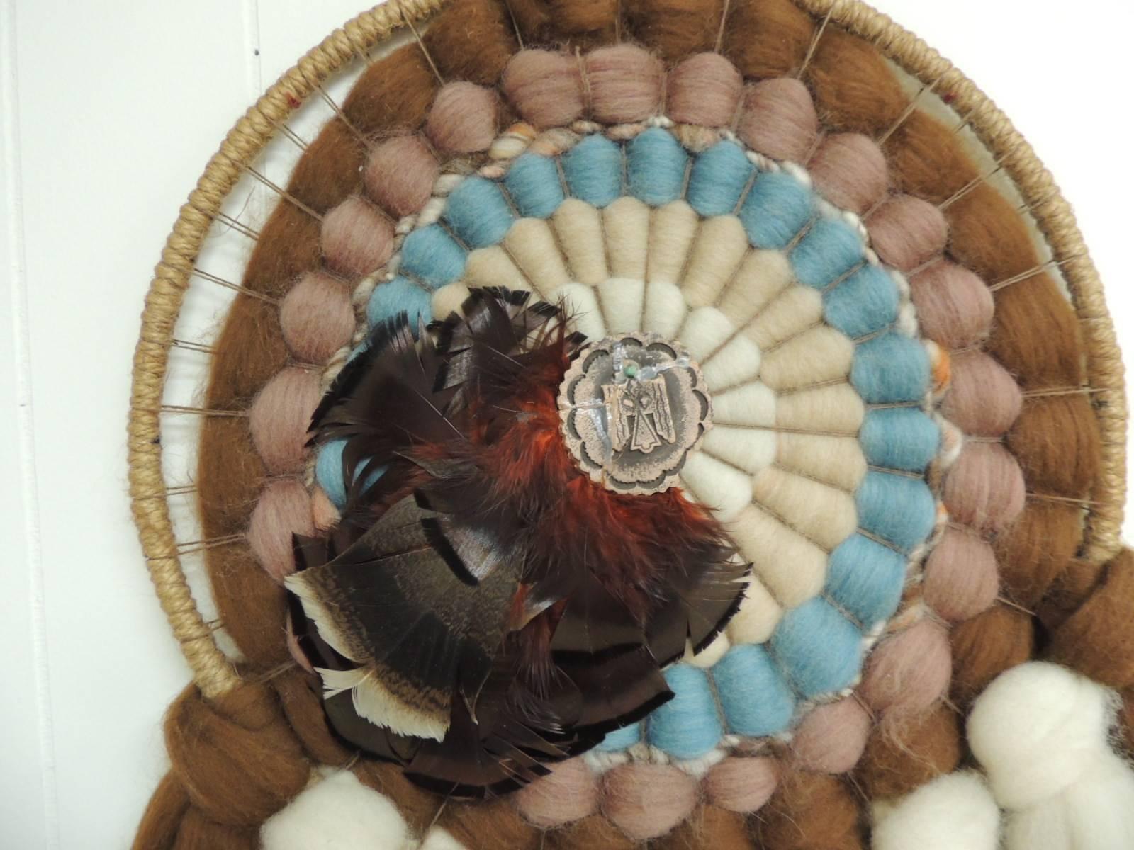 This item is part of our 7Th Anniversary SALE:
American Indian round wall hanging sculpture made with feathers, wool, leather, twisted yarns and wood. Boho-Chic artisanal, hand made wall art.
The dream catcher has been a part of Native American