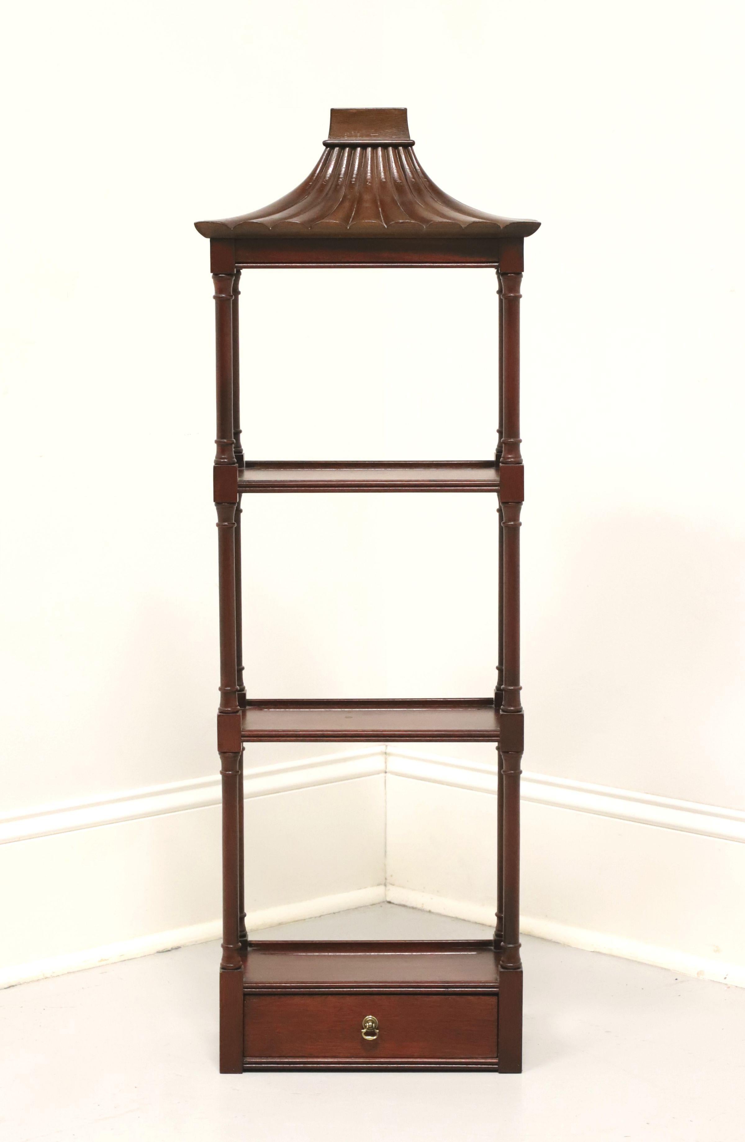 An Asian Japanese style hanging display wall shelf by Southampton. Solid mahogany with brass hardware, three flat display surfaces with low lip, pagoda like top, open column like sides and one drawer at the base. Dual brass hangers on back for wall