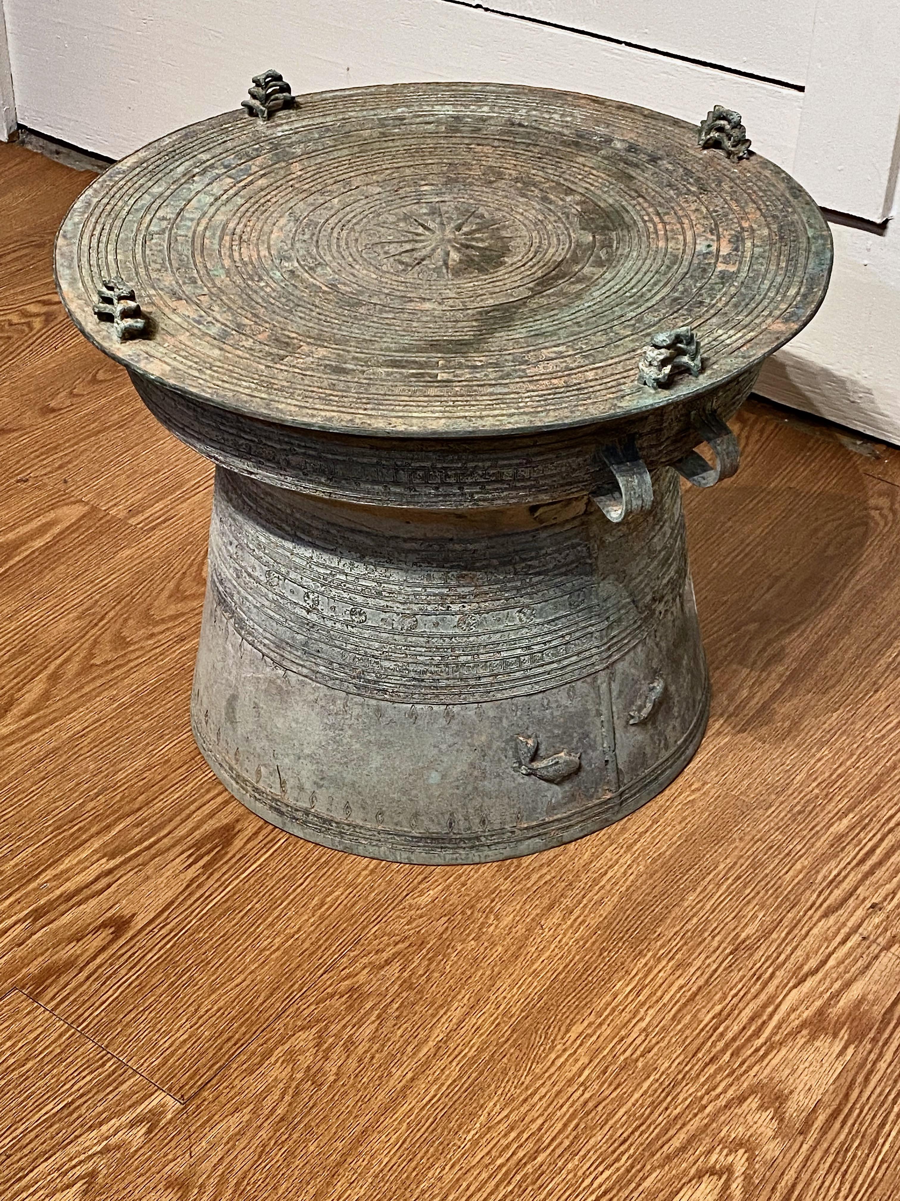 This is a very good example of a Southeast Asian Ceremonial Rain Drum. The drum is beautifully cast in solid bronze and is detailed with cast elephants, carp, bees, foliage, frogs and various symbols. The drum has acquired a wonderful green patina