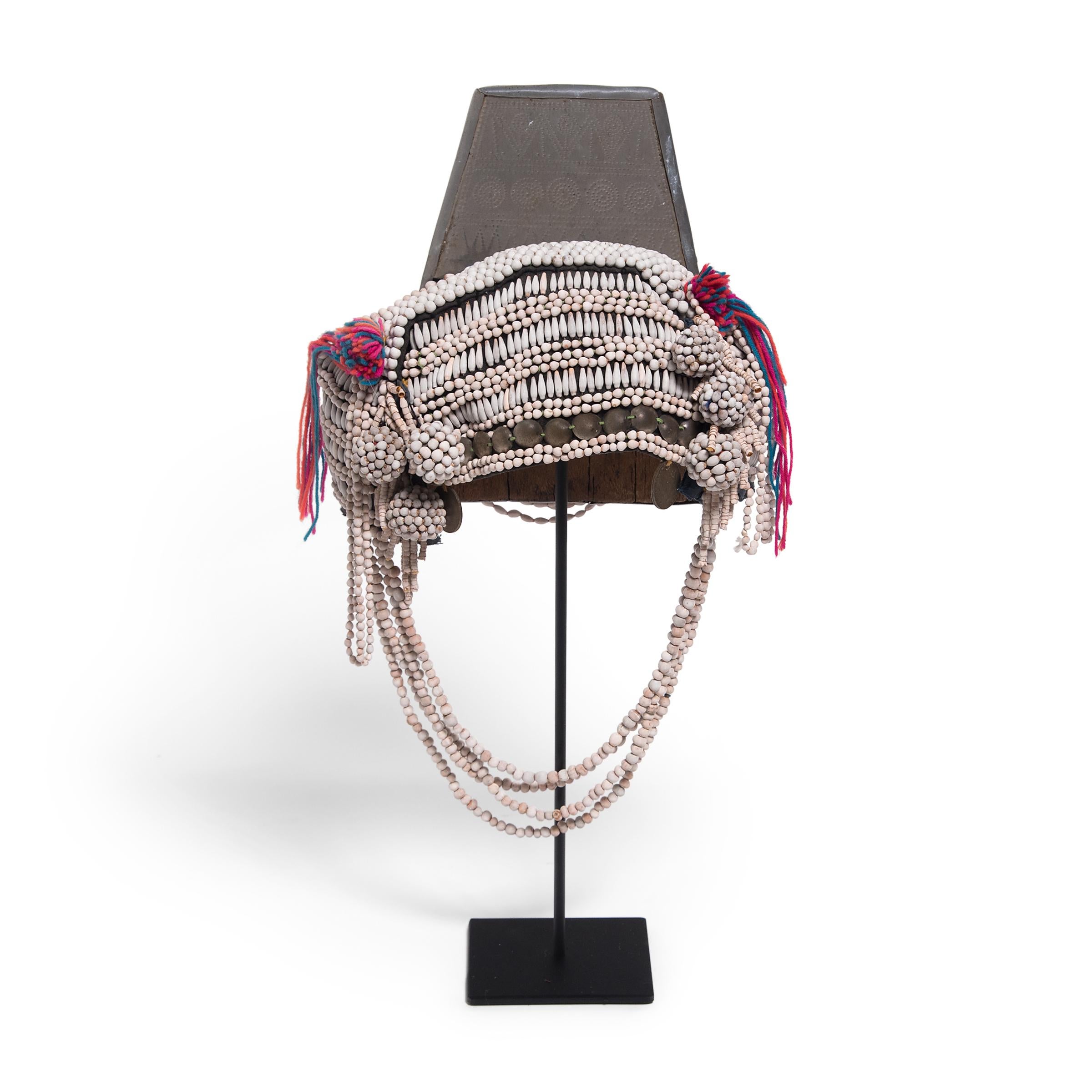 Worn to indicate her age and marital status, this densely beaded headdress was part of the daily attire of an Akha woman of Southeast Asia. As much an expression of individual style as it is a measure of social standing, the Akha headdress is