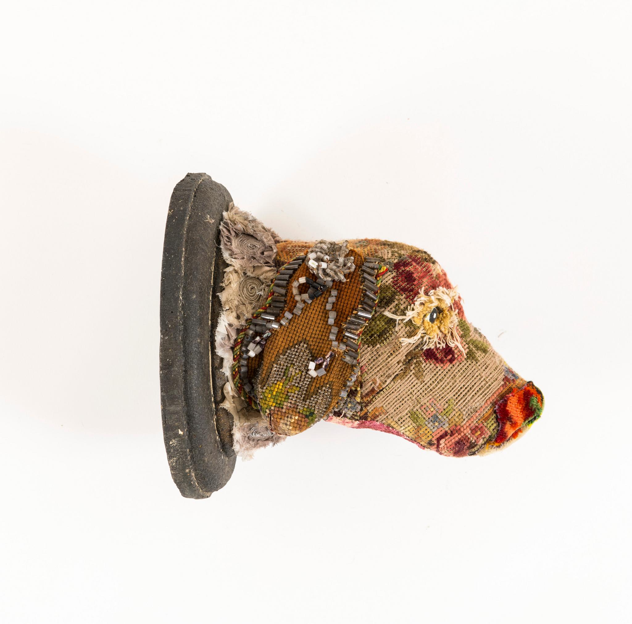Sandy Dog Head Mount with Victorian beadwork, needlepoint, cut velvet, lace, and mohair.

Mary Lou Marks is mother hen and artist to Southern Beasts. She meticulously embellishes each creature with carefully selected quality antique fabrics,