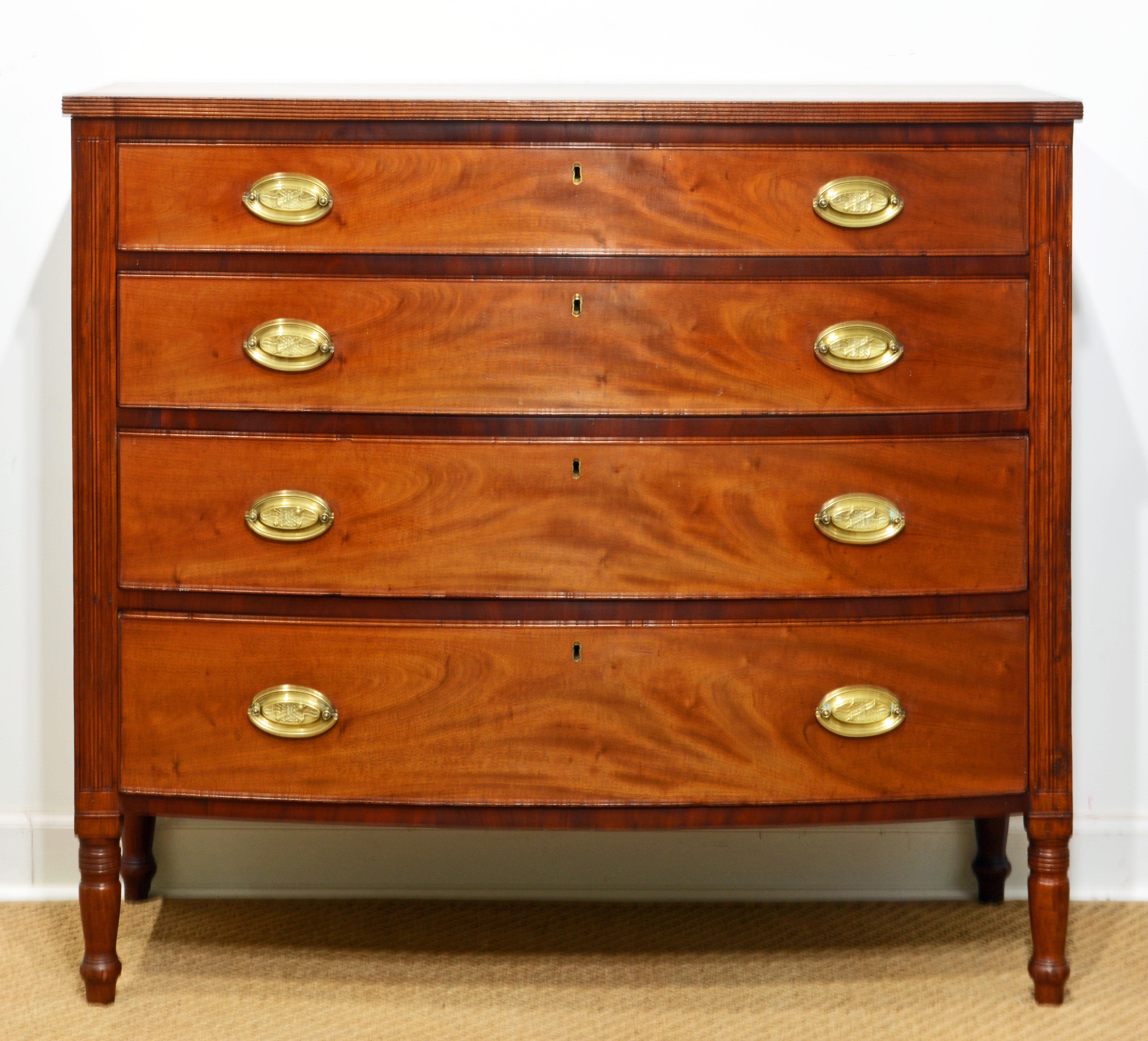 Southern Federal Sheraton bowfront chest, walnut with flame mahogany raised edge drawers. Slightly overhanging, shaped and reeded solid walnut top, 4 graduated full-length bow front dovetailed mahogany drawers with the original oval brass pulls and