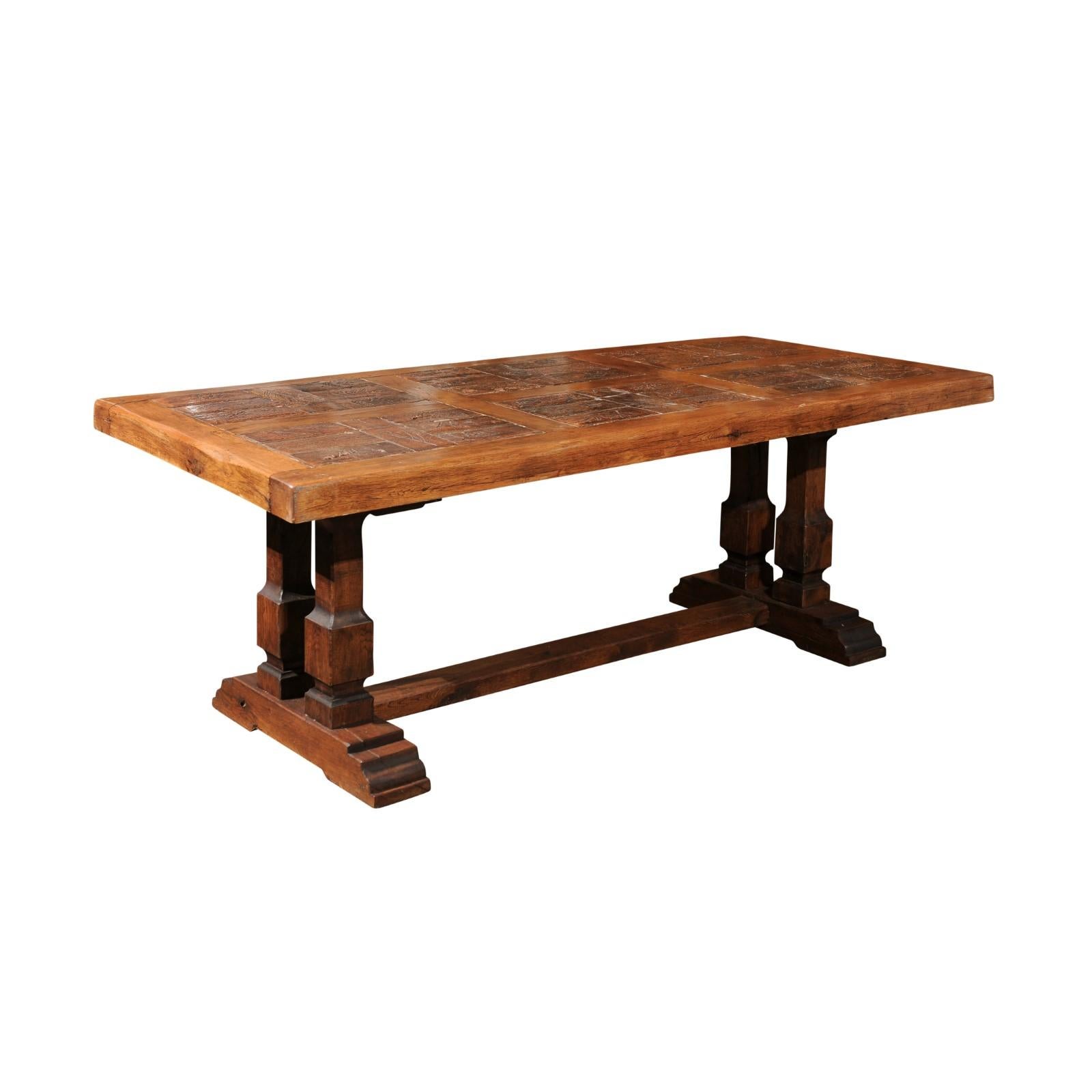 A Southern French Brutalist solid oak dining room trestle table with hand-made terracotta bricks inset top. This Southern French Brutalist solid oak dining room trestle table from the mid-20th century stands as a testament to unique design and