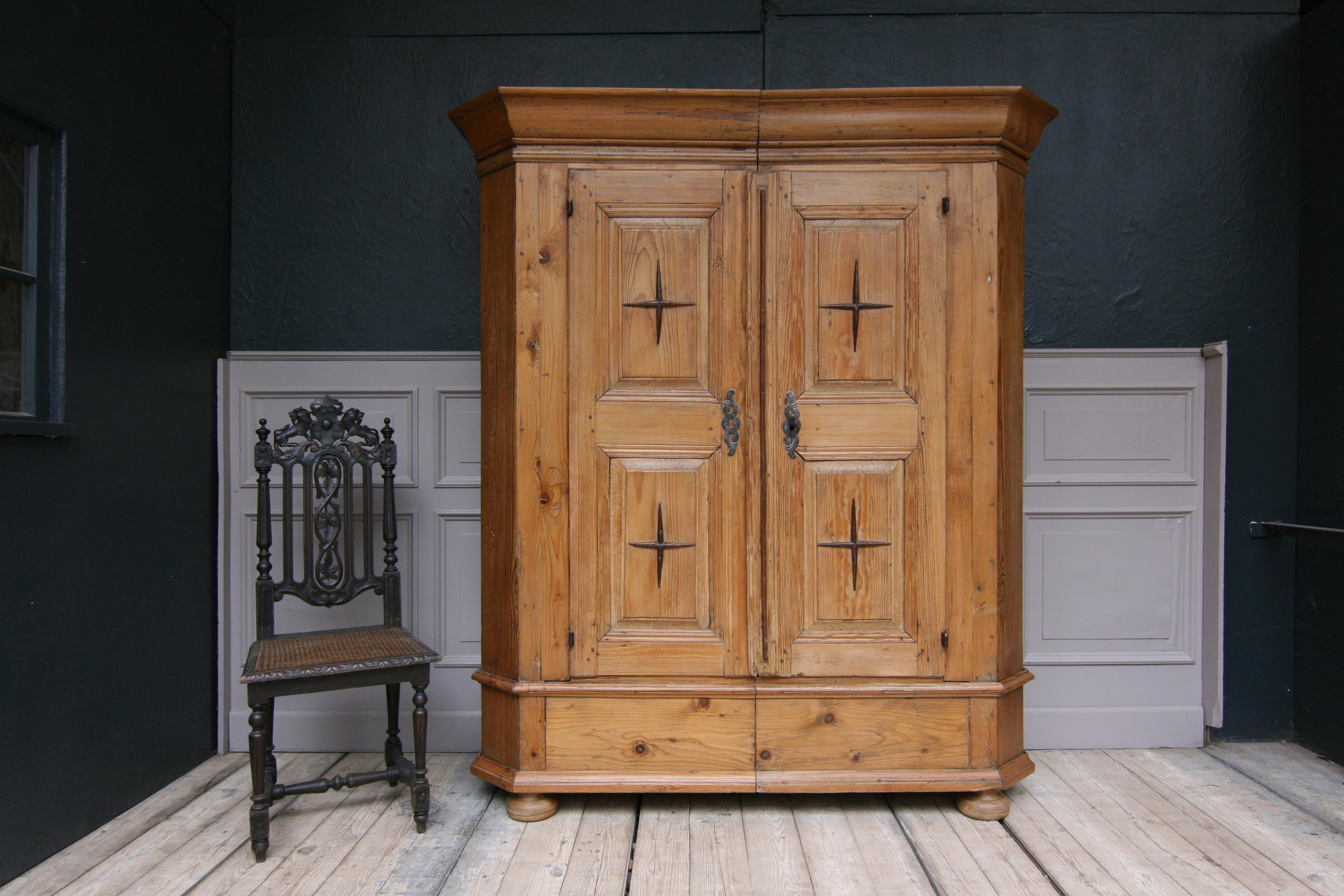 Baroque cabinet or Armoire from Southern Germany, circa 1800. 

 2-part split cabinet standing on 4 squeezed ball feet with 2 doors on hand-forged iron fittings with hand-forged iron nails. Doors in frame construction with hardwood applications on