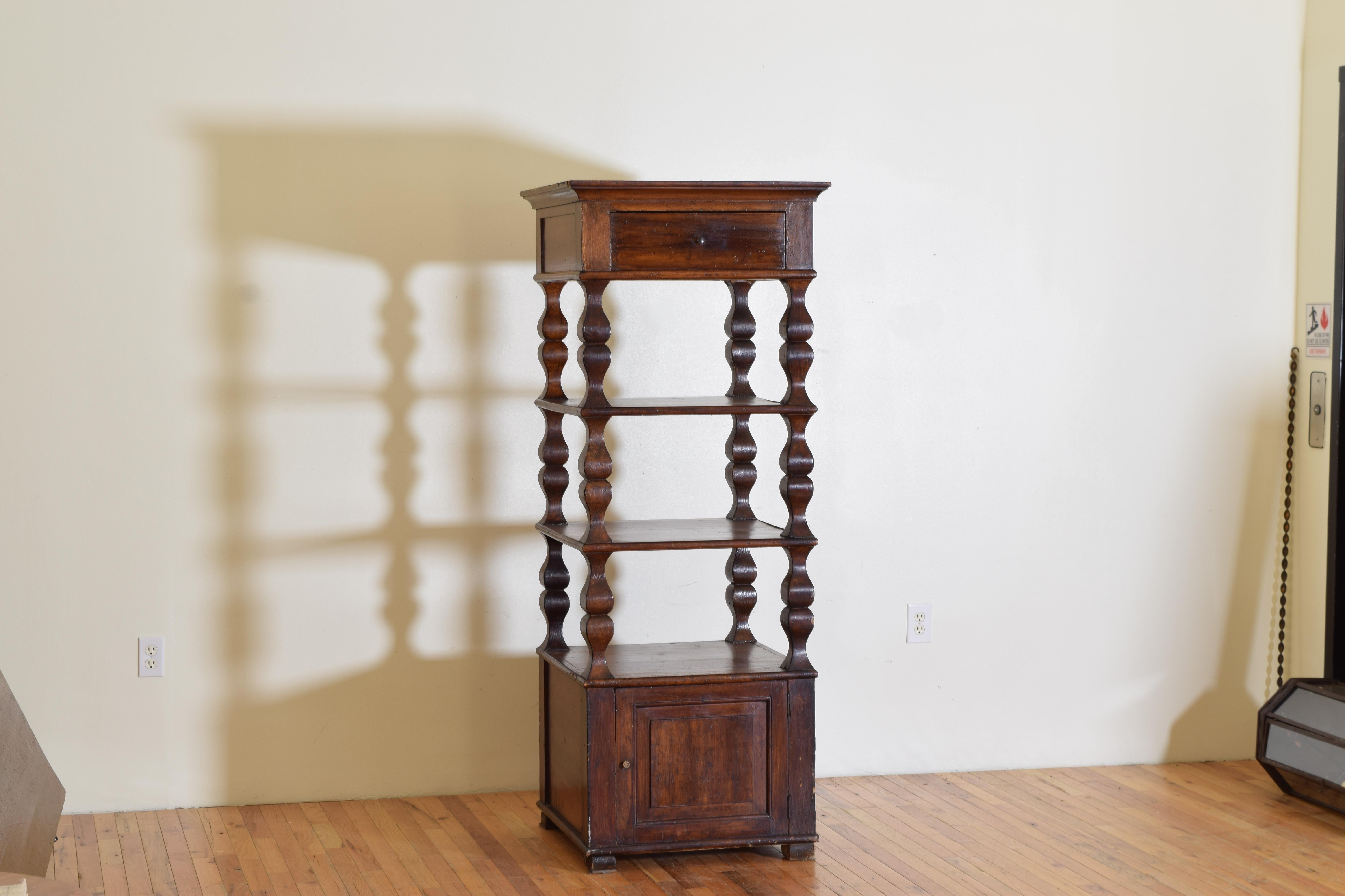 This very unique etagere has an upper portion with a square top with a tapered molded edge atop a case with one drawer atop three tiers of shelving between shaped supports in the LXIV taste, the bottom portion housing a storage space accessed by a