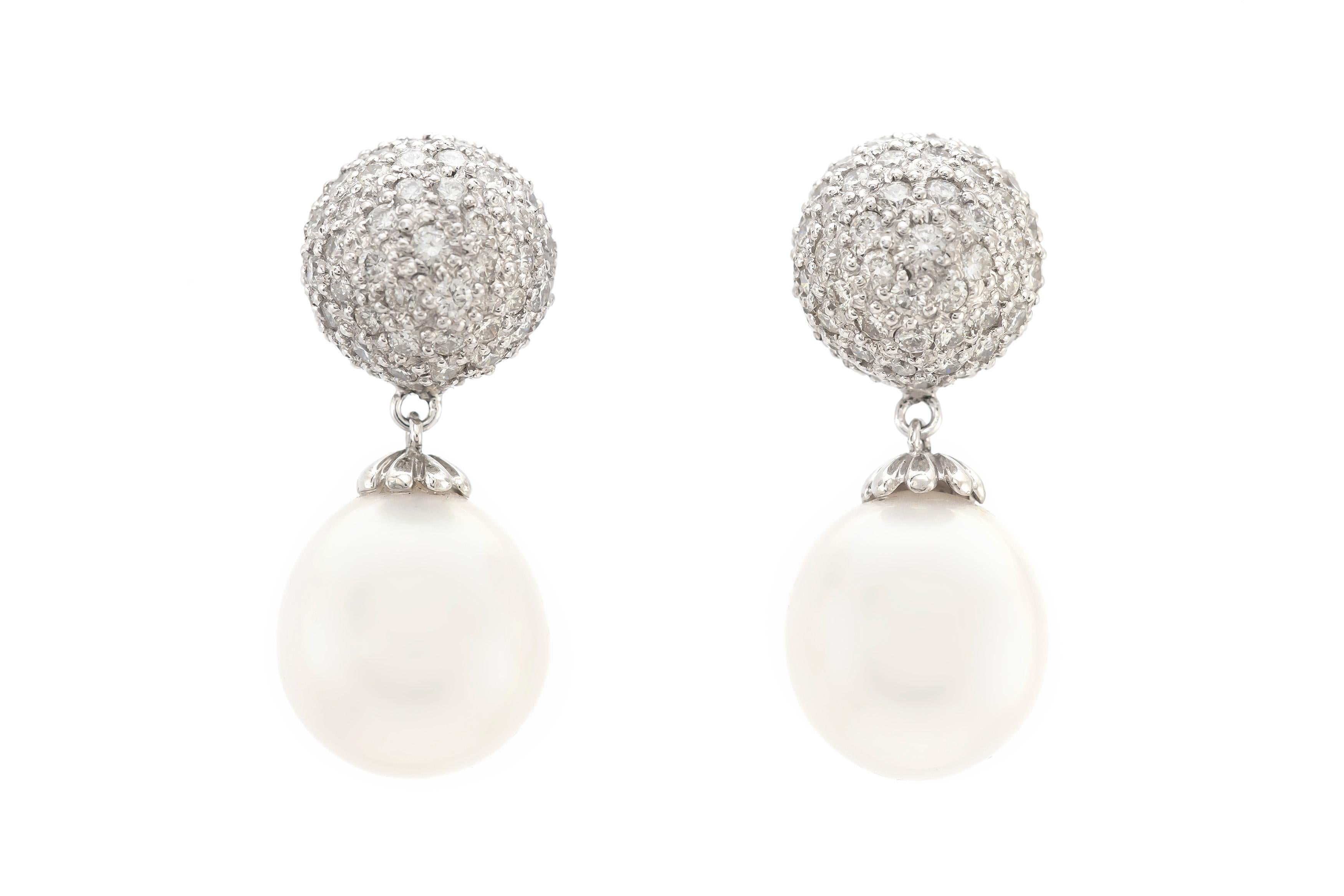 The earrings are finely crafted in 18k white gold with two beautiful South Sea pearls and with diamonds weighing approximately total of 3.41 carat.