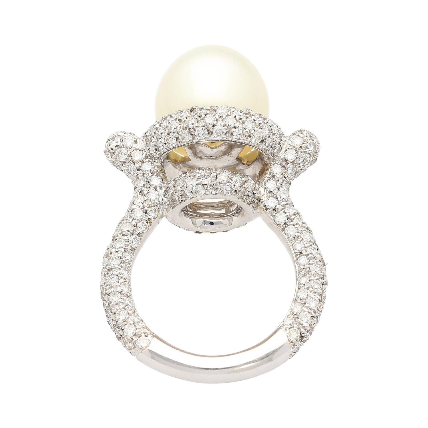 12.3mm cultured Southsea white pearl and diamond pave set ring. Set in 18k white gold. The pearl is clean, lustrous, and very symmetrical. Adorned with 3.44 carats in natural diamonds and beautifully pointed edges above the shank.  

Details: 
-