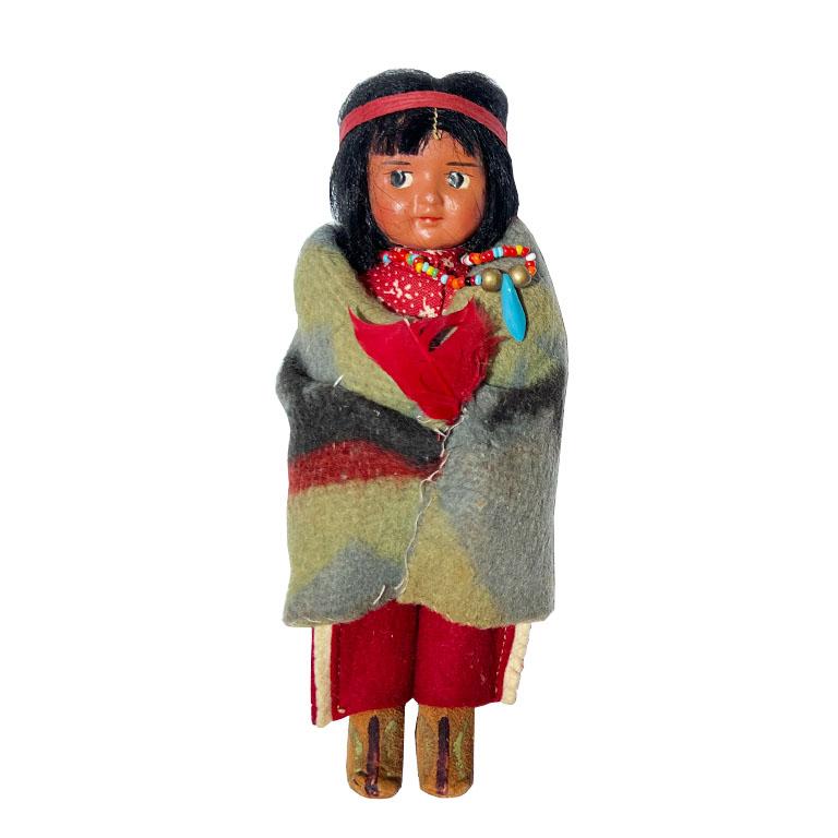 A set of four genuine Skookum dolls. Made with leather, real hair, wool, and fabric, these Native American dolls were the original American Girl. Skookum dolls were made in the 1930s, making this set nearly a century old. Each woman wears a Native
