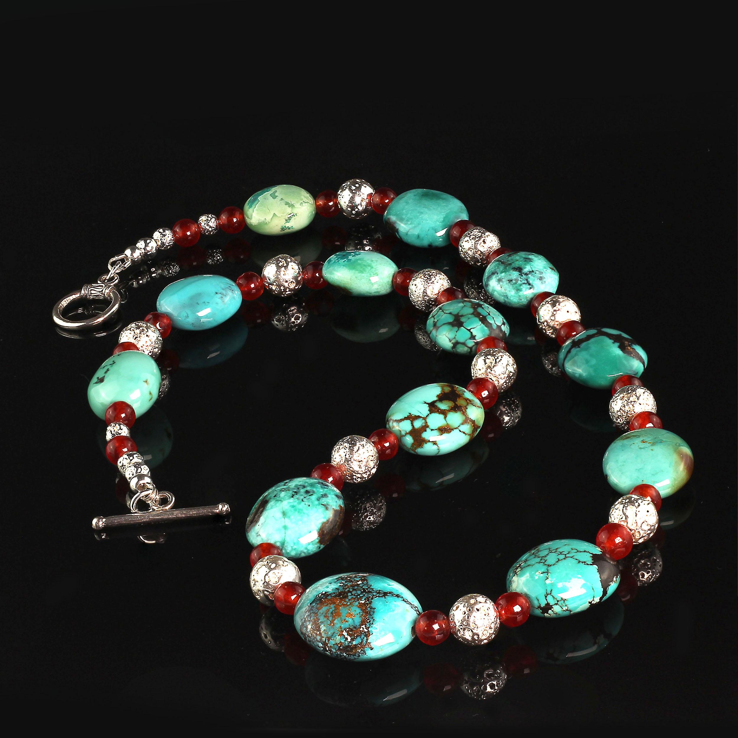 Southwest Influence necklace of graduated Turquoise matrix nuggets alternating with transparent Carnelian and Silver lava rock. This highly polished Turquoise graduates from 18 X 15 MM to 21 X 19 MM. The round Carnelian is 6 MM. And the Silver lava