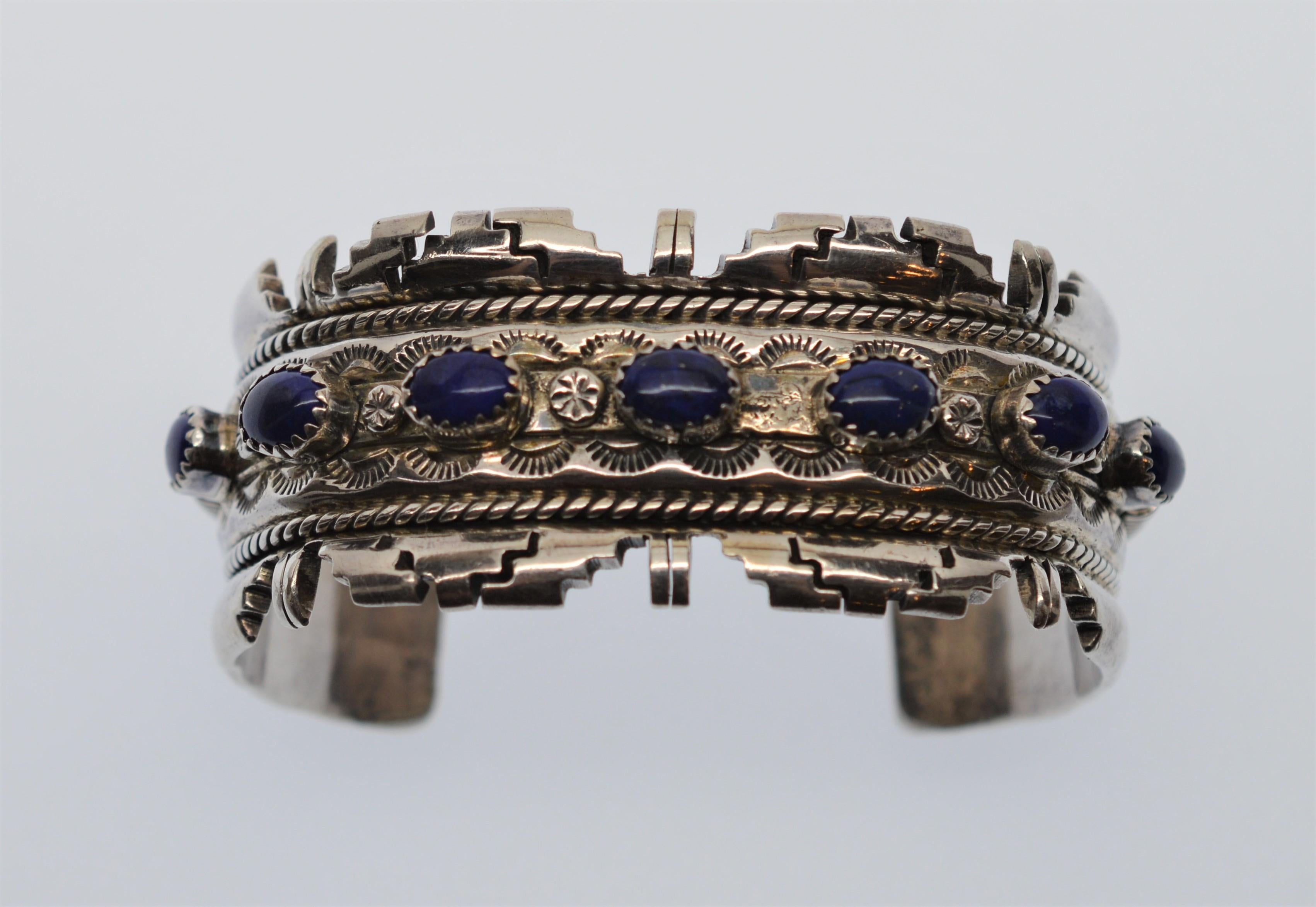 Intricately crafted Southwest Sterling Silver Cuff Bracelet with seven deep dark Blue Lapis Stones.
This impressive Silver Cuff Bracelet is a statement piece with it's extraordinary cast and hand-chased detail in Sterling Silver and inlaid Lapis