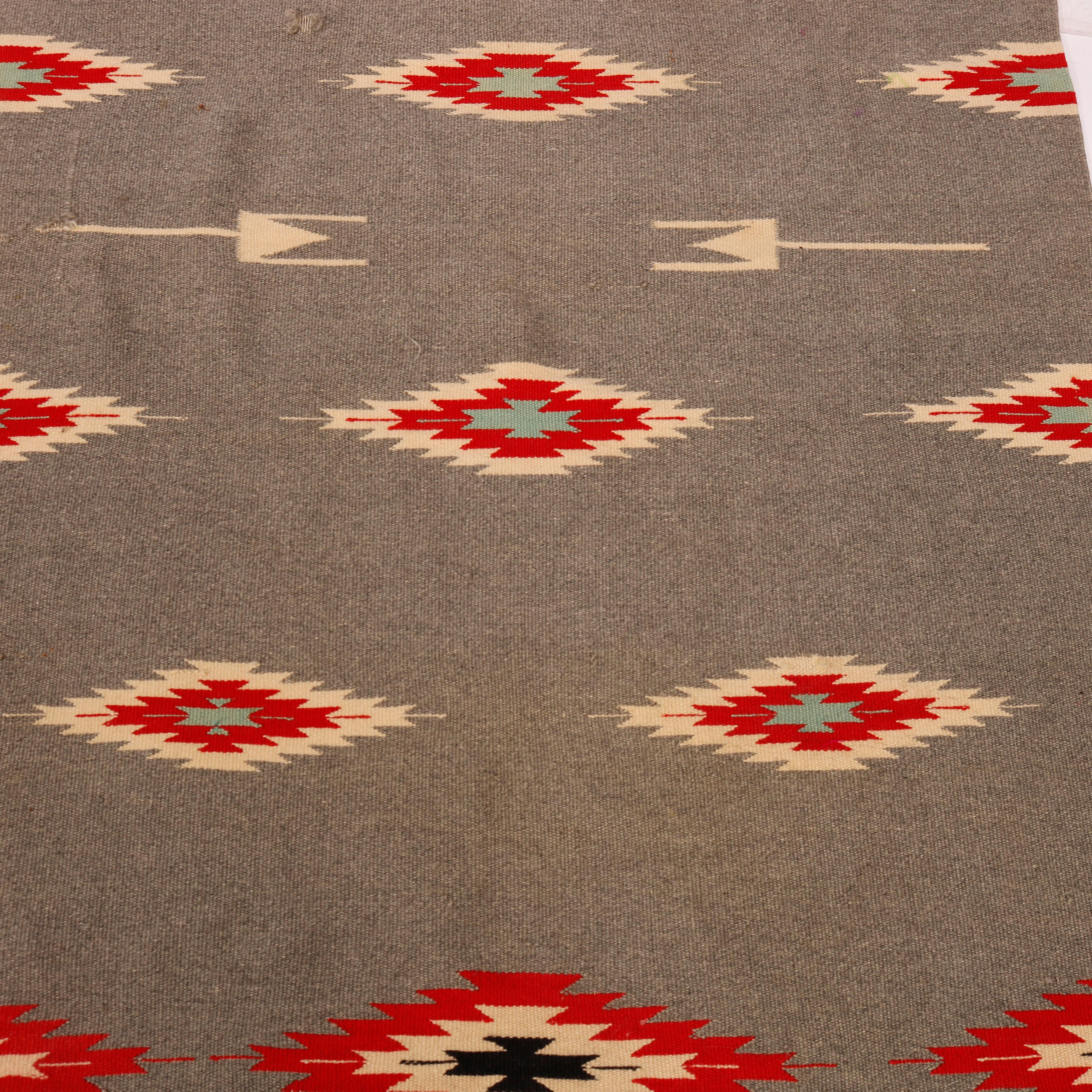 A Southwestern Native American Indian Navajo rug offers hand woven wool construction with design having repeating diamond pattern, 20th century

Measures- 78.5''L x 36.25''W x .5''D.

Catalogue Note: Ask about DISCOUNTED DELIVERY RATES available to