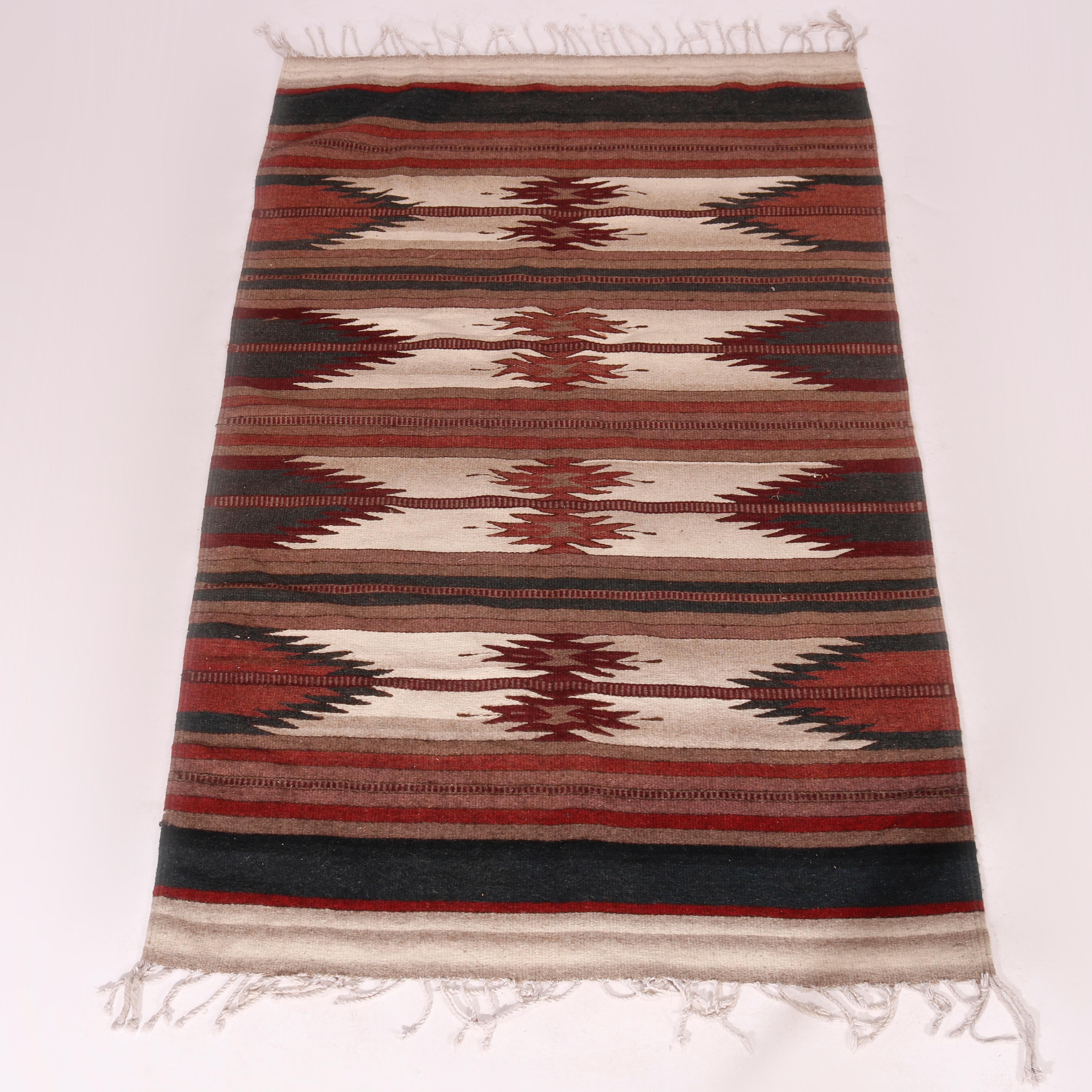 An antique Southwestern Native American Indian style rug offers striped serrated eye dazzle design, c1930

Measures - 76.5''L x 45.5'' W x .5'' D.
 
Catalogue Note: Ask about DISCOUNTED DELIVERY RATES available to most regions within 1,500 miles of